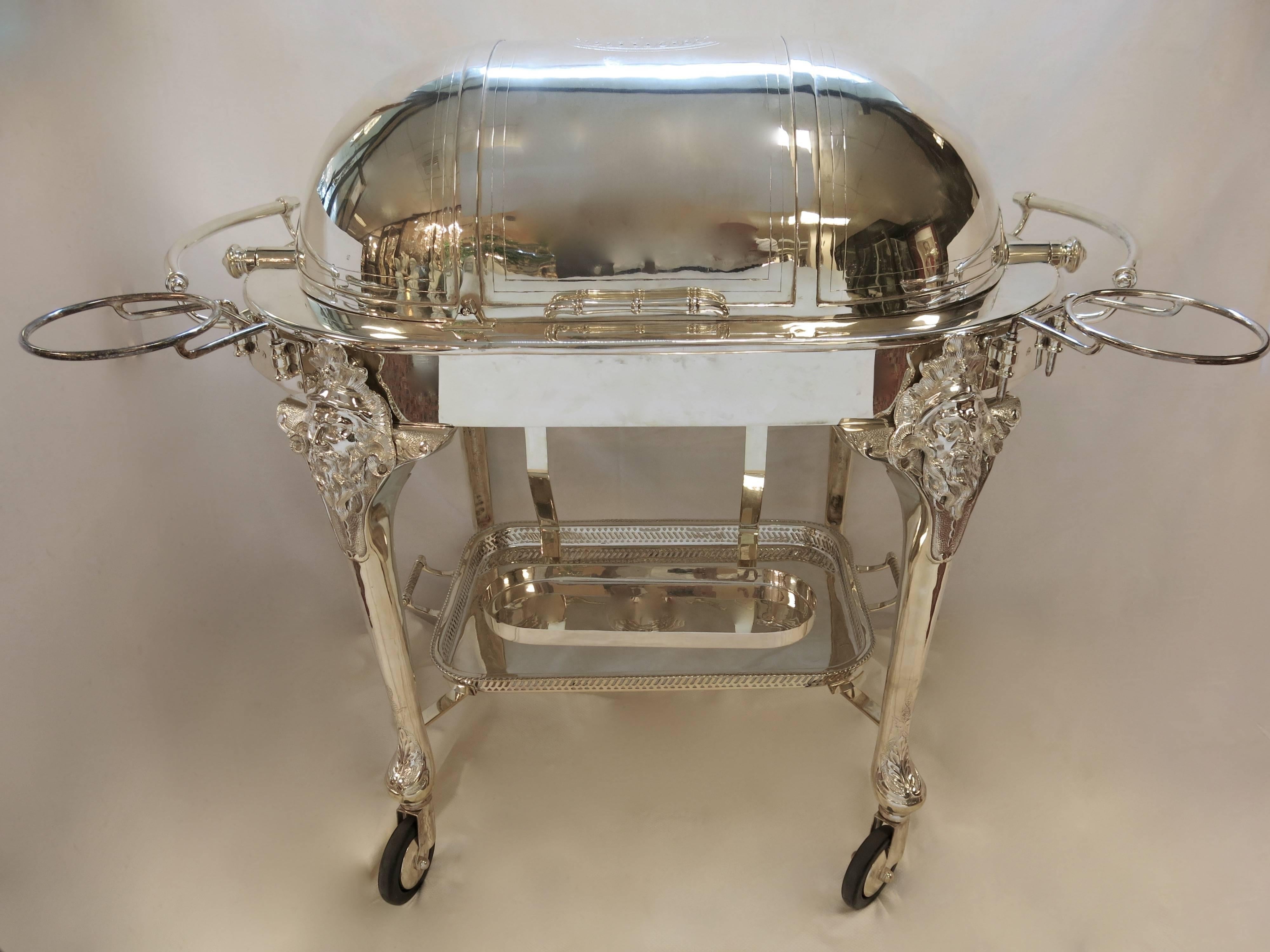 Stunning, large, decorative and usable Sheffield silver plate beef trolley. Complete with hot water jacket, sauce pots, vegetable dish, carving tray, under tray and three burners. Bacchus mask caps on each of the legs, and detachable plate holder /