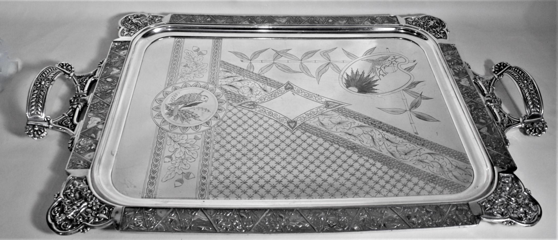 This extremely large and substantial silver plated serving tray remarkably unsigned, but believed to have been made in the United States in circa 1890 in the period Aesthetic Movement style. This tray is extremely ornately decorated from the casting
