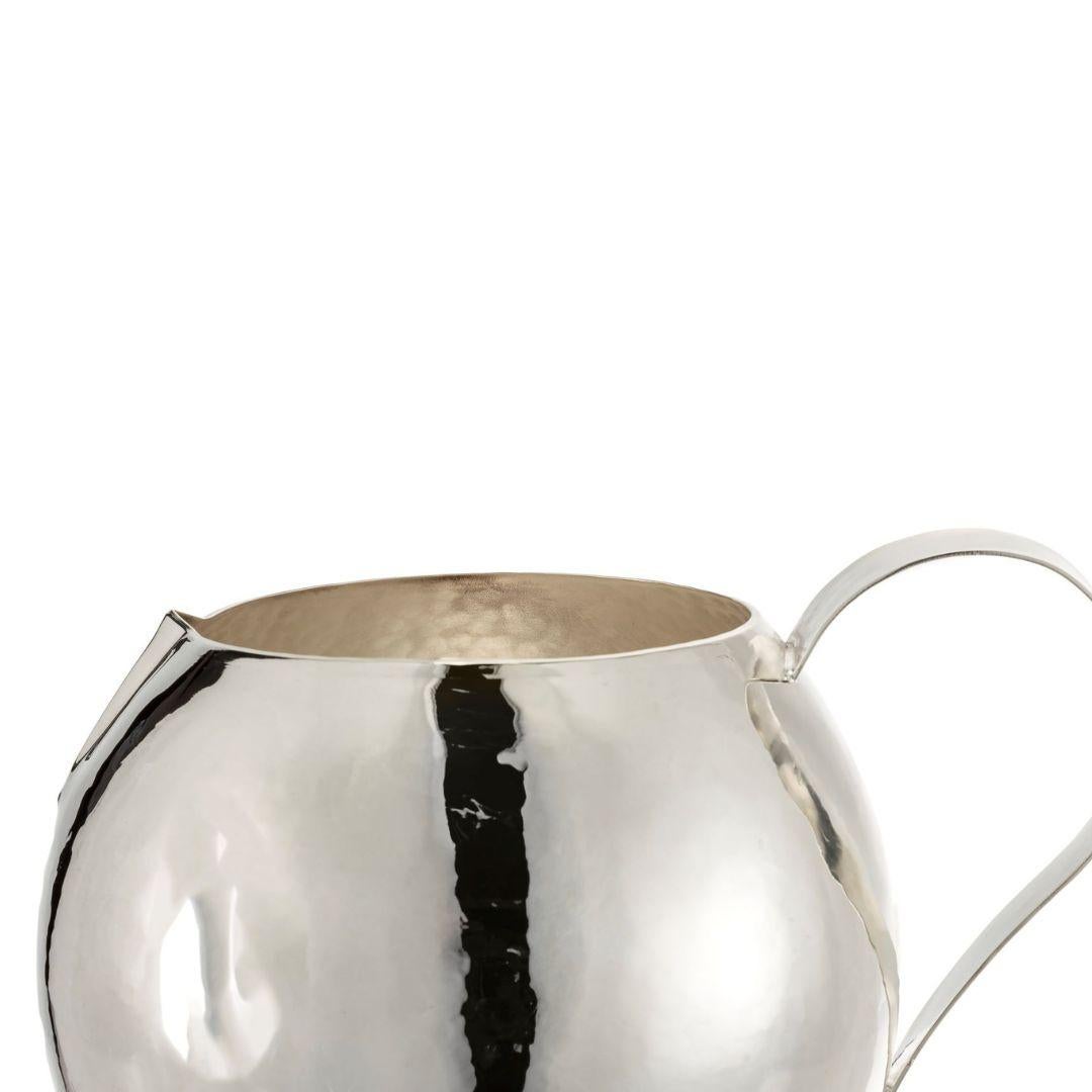 Its classic ball shape, sturdy handle, and spout make it perfect for serving wine or water of an elegant and sophisticated table setting. Made from high-quality hammered brass it has a silver plate that enrich and makes it durable over time. 

 