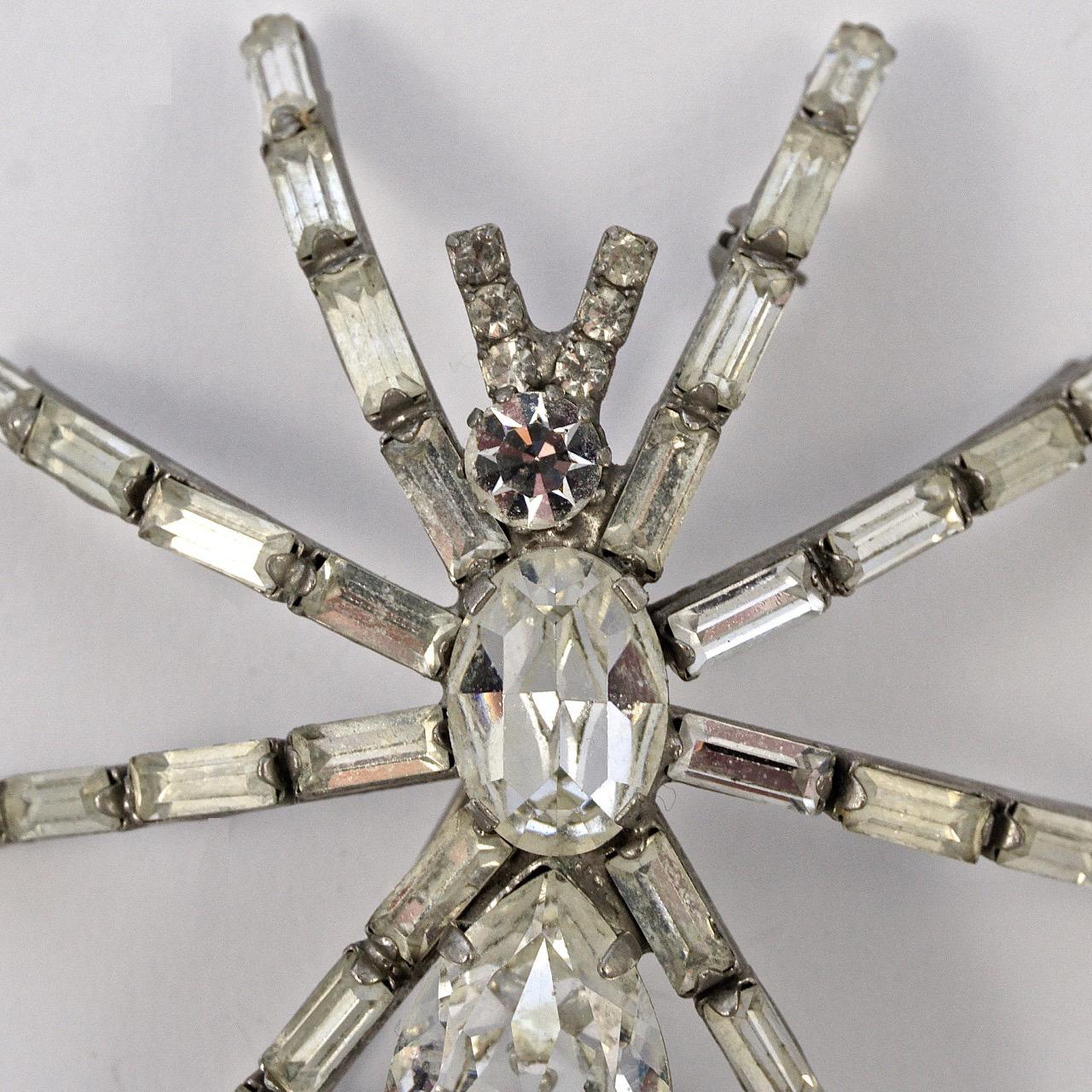 Fabulous silver tone figural spider brooch embellished with clear faceted rhinestones. Baguettes for the legs and round, oval and teardrop shaped rhinestones for the body, they are prong set. This brooch is possibly from Butler & Wilson. Measuring