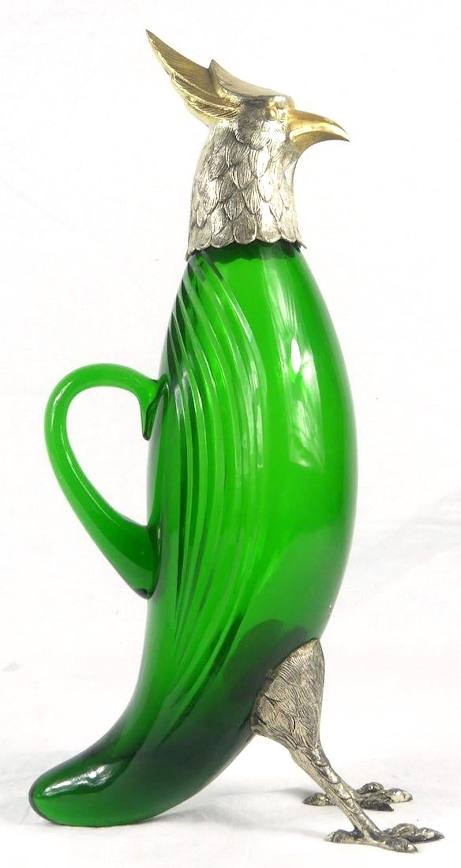 Large silver (.800) and vermeil figural green glass bird decanter each silver part stamped Spain and hallmarked, the glass body finely engraved.