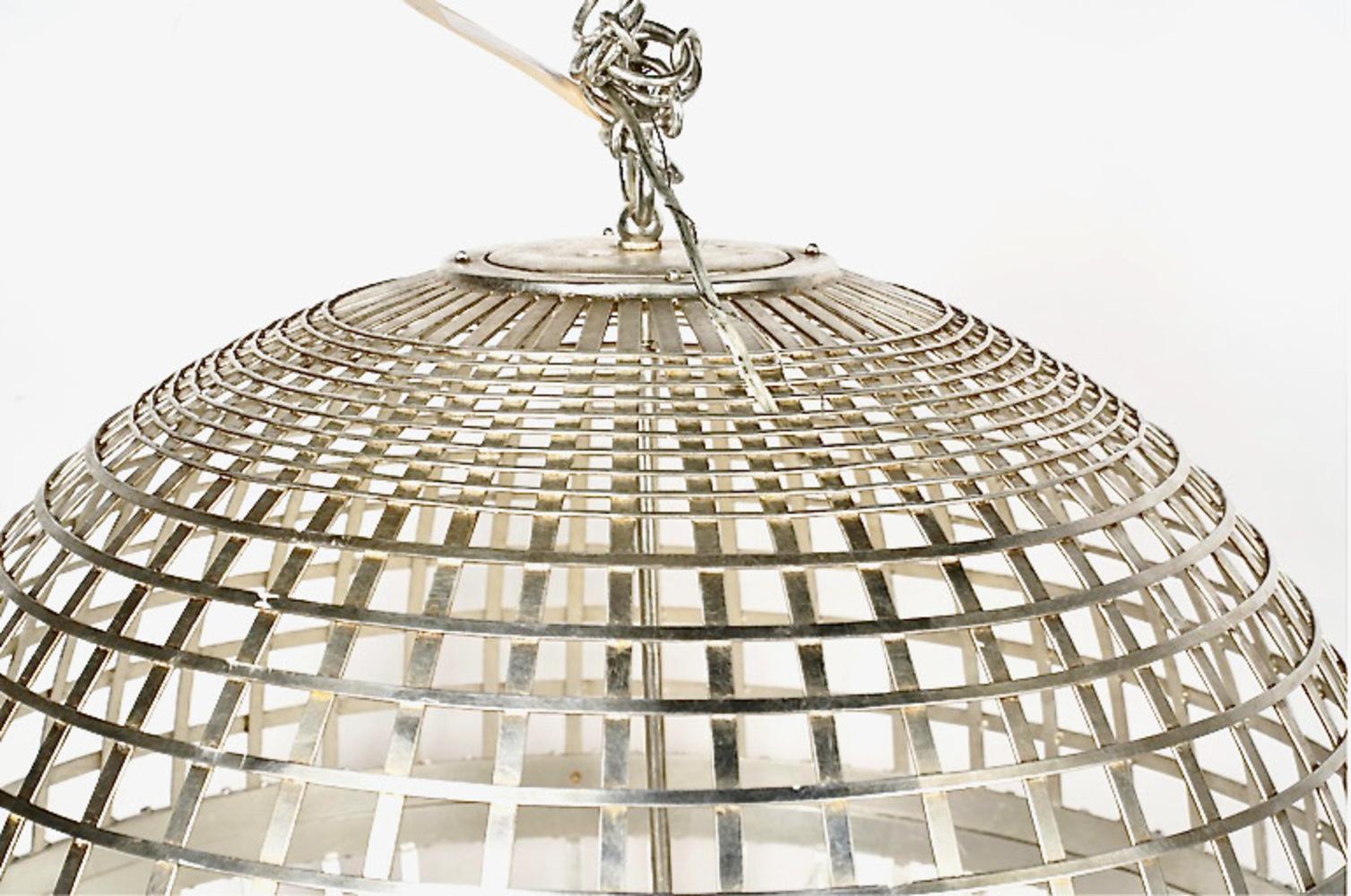 This is a very impressive light fixture: aside from its very large breadth, the silver leafed metal combined with the disco ball format makes this a standout. This fixture would feel at home in a large modern entry or living space. The disco ball is