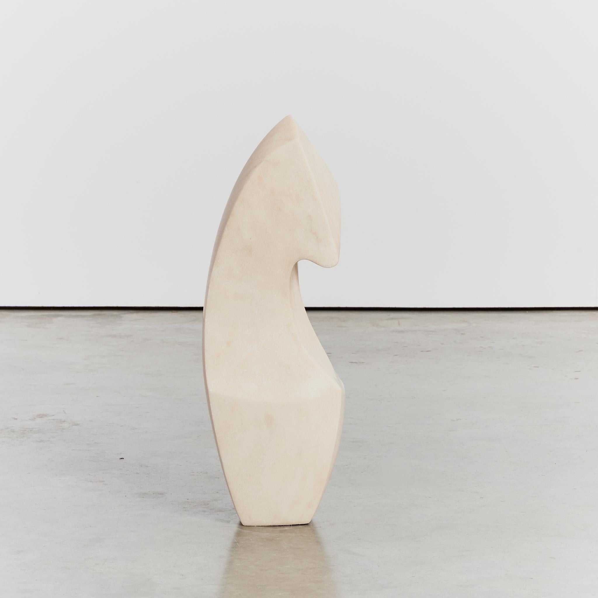 Oversized simplistic abstract silhouette, carved from a single piece of creamy  Portuguese marble from the area of Estremoz. This floor standing sculpture boasts multiple viewing angles with some facets showing subtle terracotta viening.

Artist: