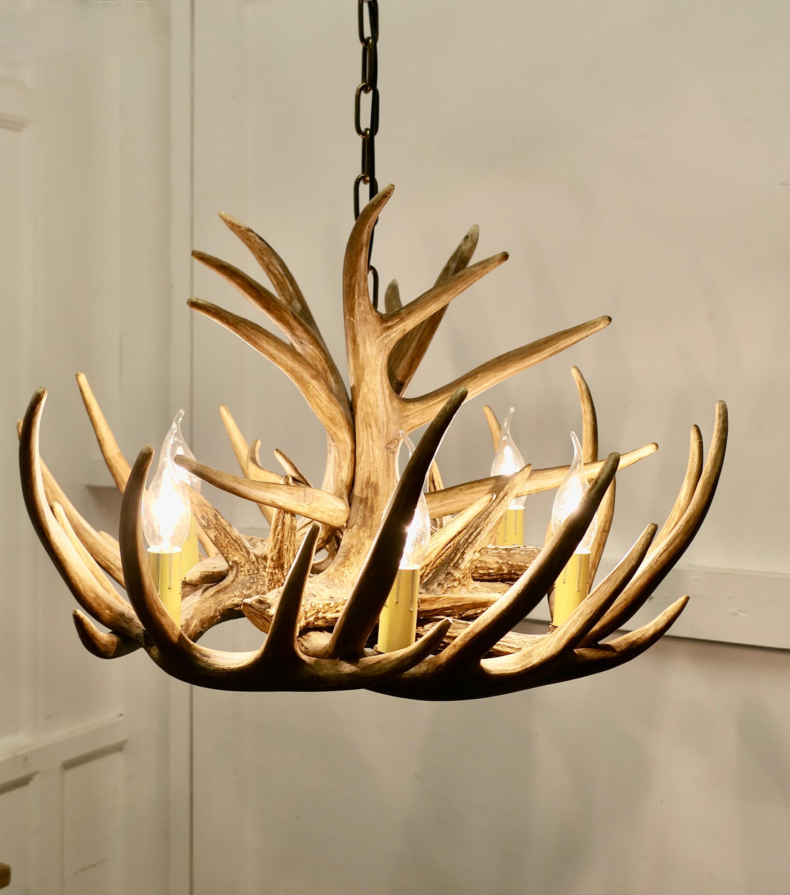 Large Simulated Black Forrest Stag Antler Hanging Chandelier
 
This is a very realistic looking piece, this chandelier design was first made in the 19th Century, and was a great favourite in Scottish hunting lodges
The chandelier has 6 lamps and is