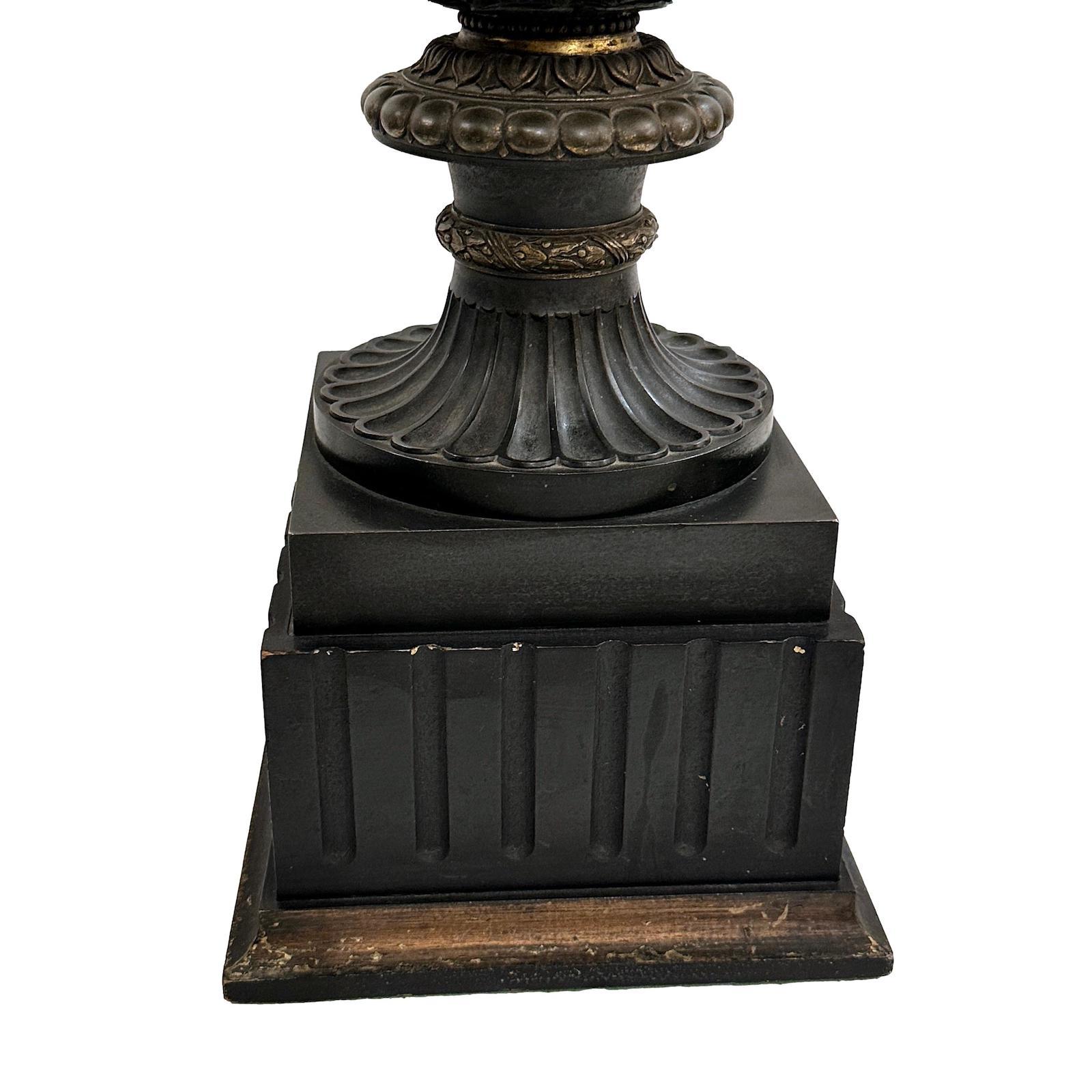 A circa 1920's French bronze urn-shaped table lamp with Neoclassic scenes on body, dark patinated finish and with some gilt details.

Measurements:
Height of body: 18