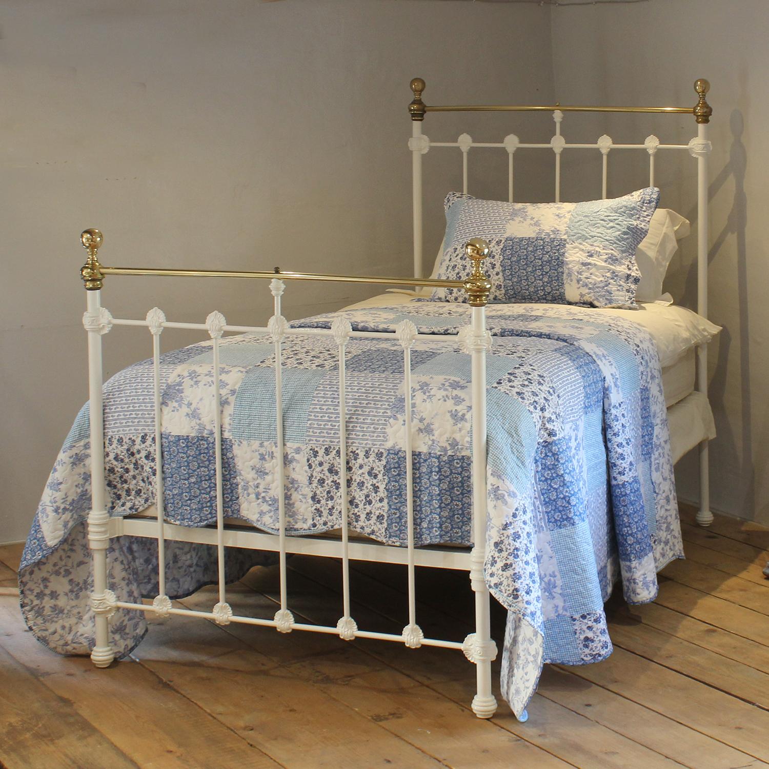 A traditional style Victorian antique bed painted in white, with straight brass top rails, and decorative castings on the head and foot board. 
This bed takes a large single 3ft 6in wide x 6ft 3in long base and mattress.
The price includes a firm