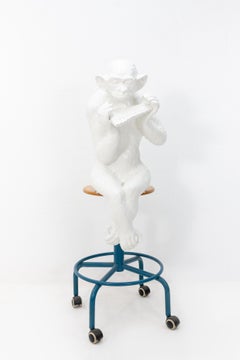 Large Sitting Chimpanzee Playing the Panpipes