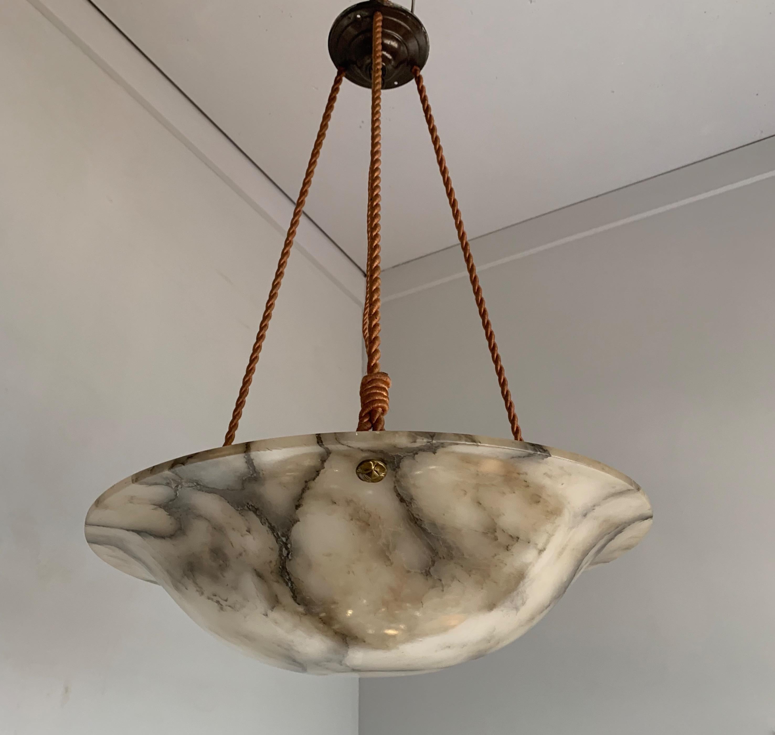 Another amazing and impressive 1920s pendant.

This early 20th century, large alabaster pendant comes with a stylish rope and canopy, which also makes it possible for us to (free of charge) change the height to one that is perfect for you. The shape