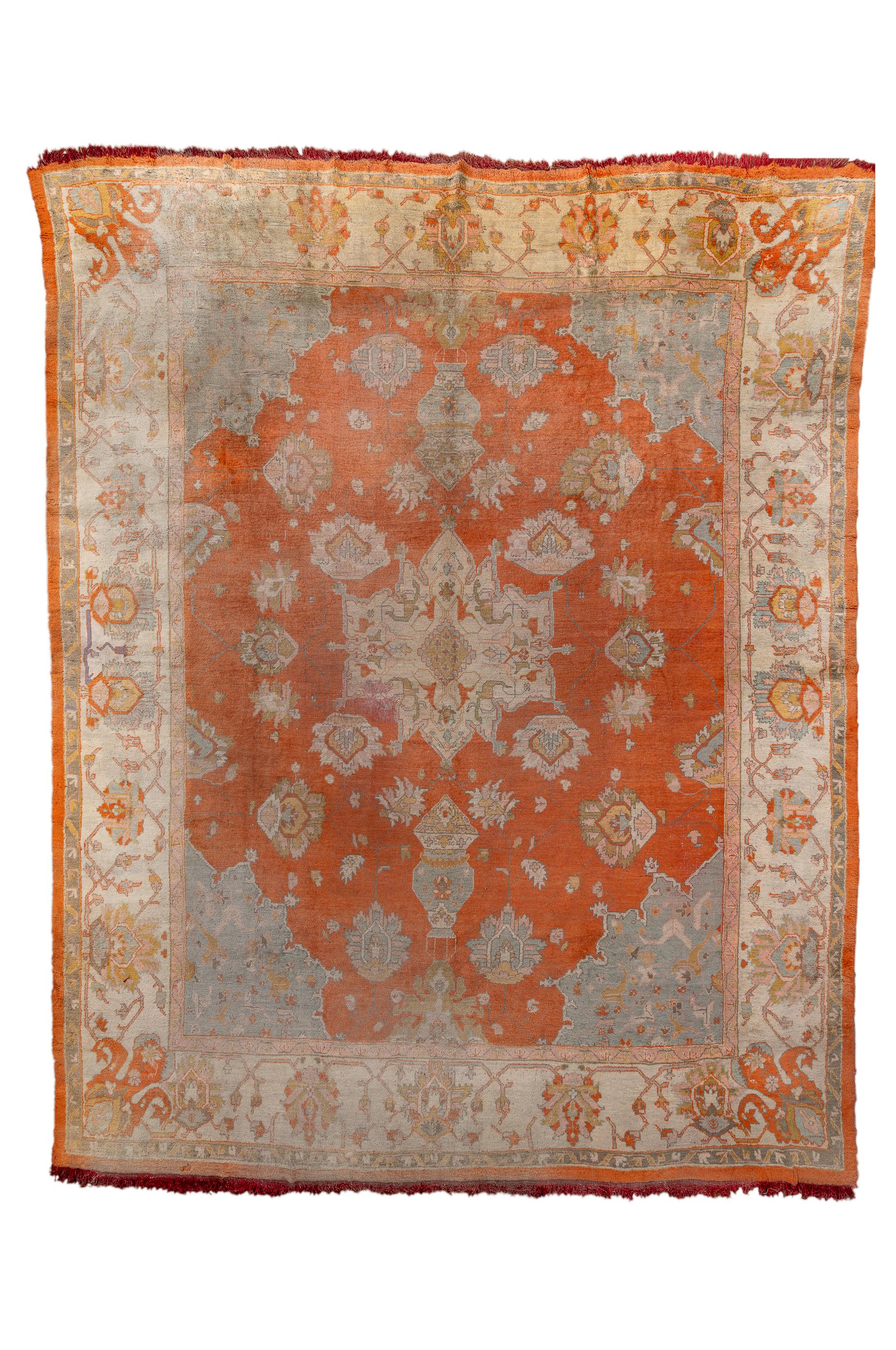 Made to compete with Persian Herizes, this Anatolian large room size carpet show a Turkey red field centred on a roughly octogrammoidal cream medallion, with convex  teal corners, two suspended mosque lamp pendants and a supporting school of mobile