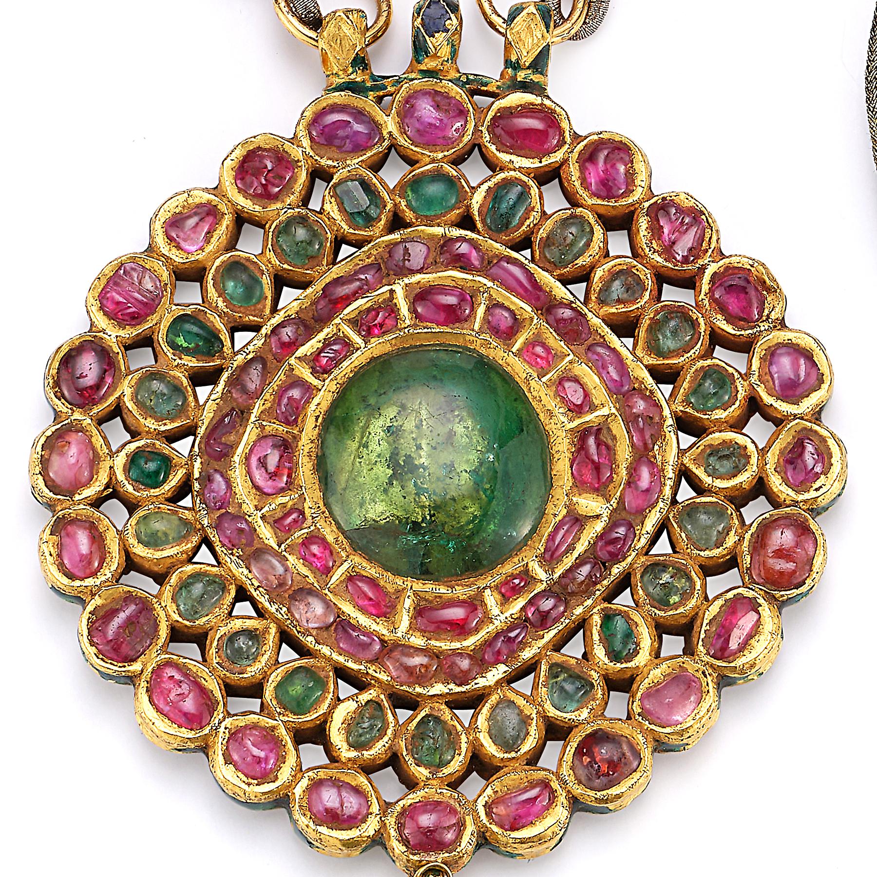 Large Size Antique Indian Pendant Necklace

Set with large cabochon emerald surrounded by cabochon emeralds & rubies set in 22k yellow gold with an emerald bead drop. 
Superb multi color hand enamel work on the reverse.

Necklace length is