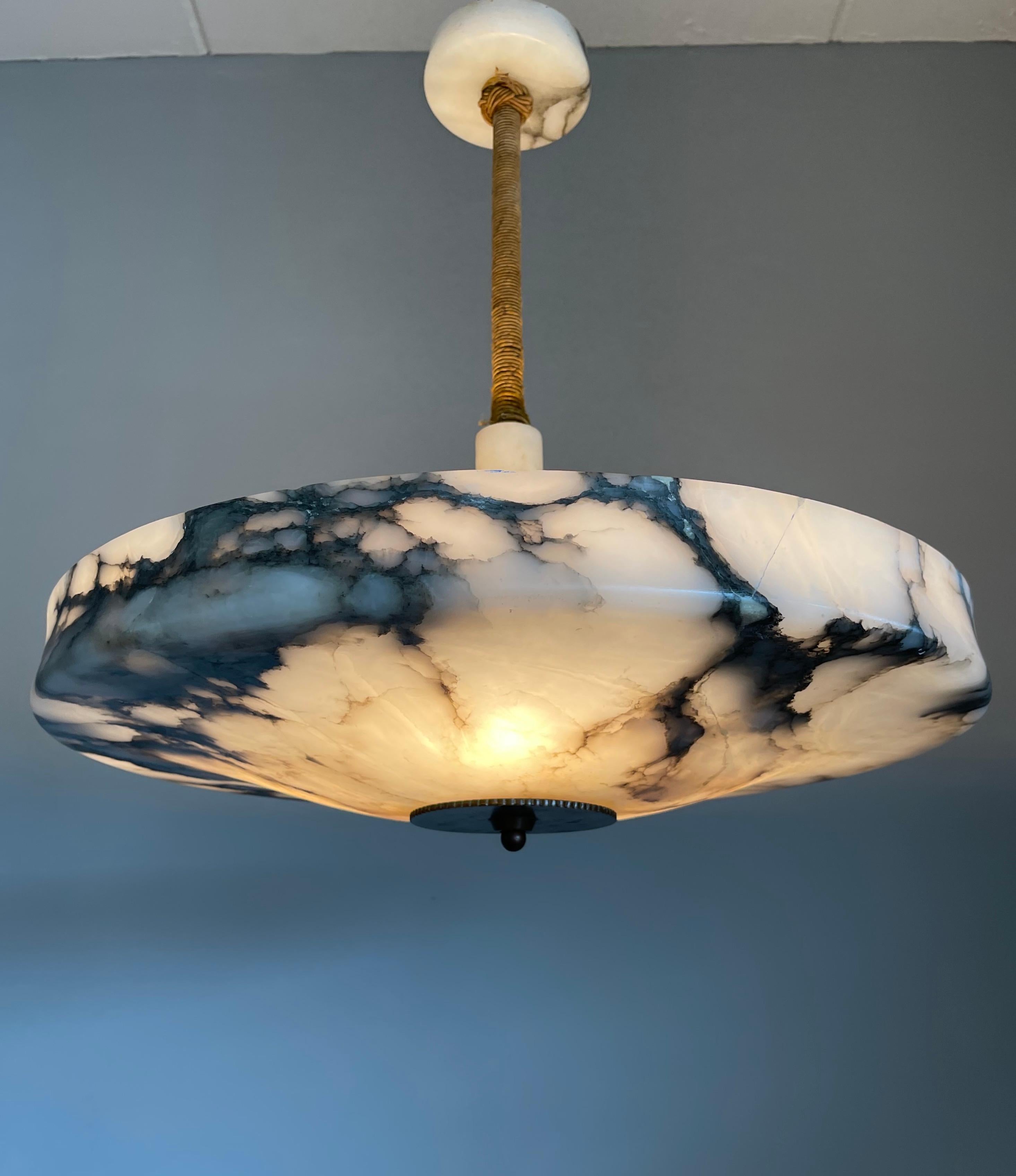 Rare and majestic alabaster pendant from the heydays of the Art Deco era.

This rare and very large size Art Deco flush mount comes with a stunning design, polished alabaster shade. This large size and almost flat alabaster shade is designed in