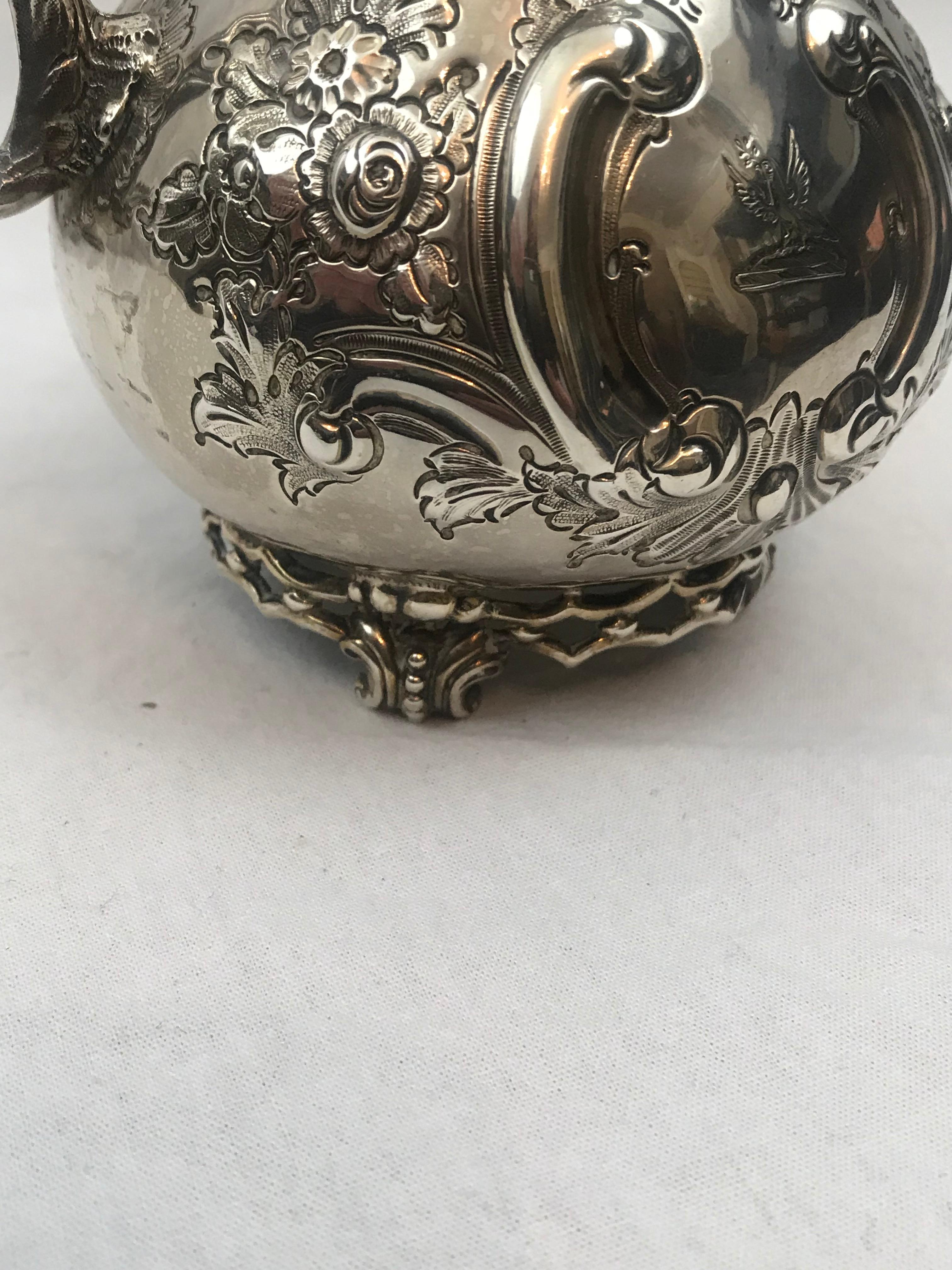 Lovely large-size cream and sugar. Irish sterling silver.
Date marks for Dublin 1887-1888.
 
Repousse roses and leaves. Engraved crest of a bird. Pierced gallery at foot.
 
Sugar bowl. 9