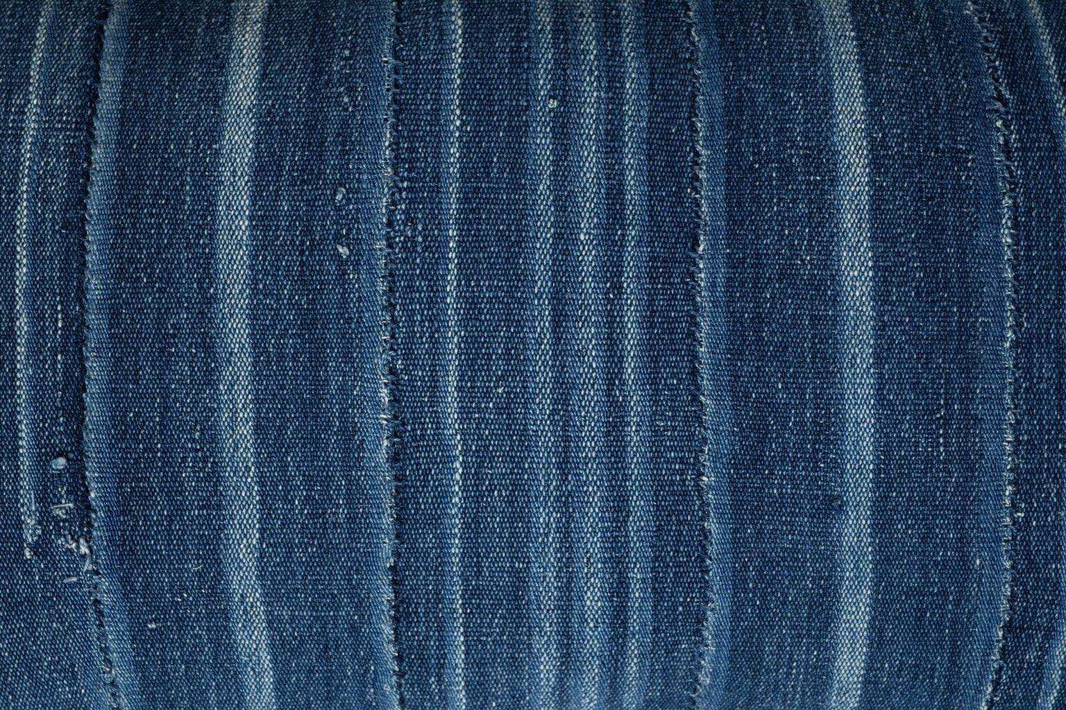Large size faded indigo tone-on-tone stripe lumbar cushion made from vintage handwoven and hand-dyed slubby cotton fabric. Versatile tone-on-tone indigo stripe runs vertically on one face and is self-backed with same fabric running horizontally.