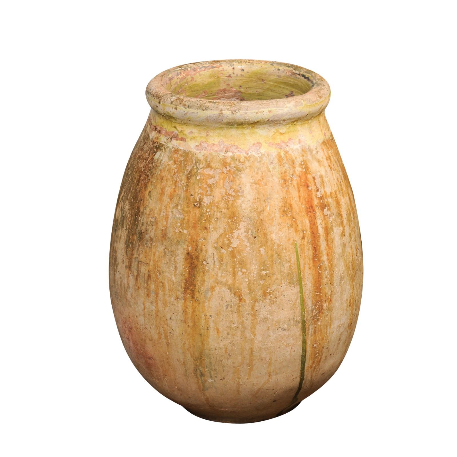 A large size French Provincial terracotta olive oil Biot jar from Provence with traces of yellow glaze and green dripping from the 19th century. A magnificent large-sized French Provincial terracotta olive oil Biot jar from the 19th century, hailing