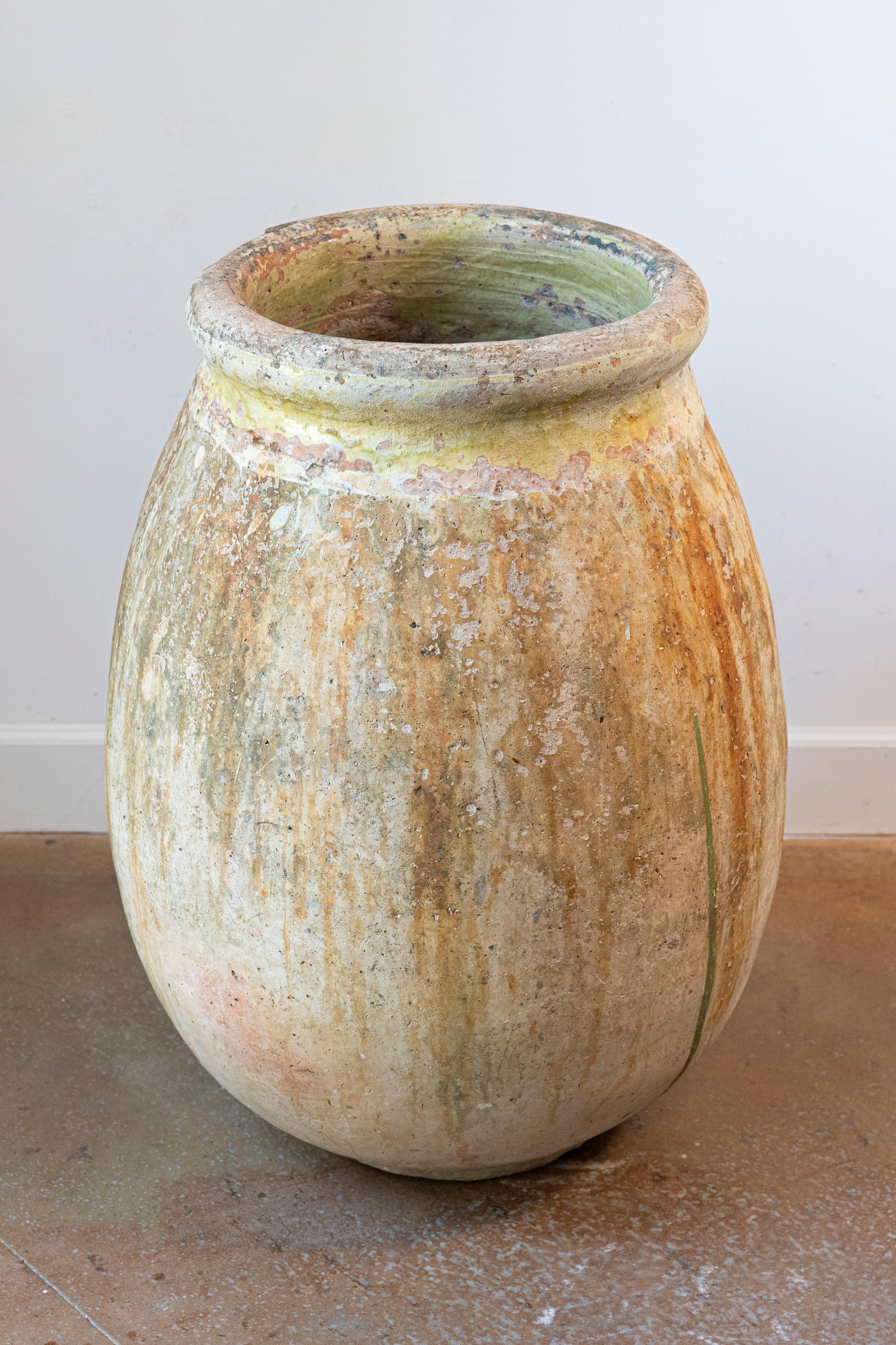 A large size French Provincial terracotta olive oil Biot jar from Provence with traces of yellow glaze and green dripping from the 19th century. A magnificent large-sized French Provincial terracotta olive oil Biot jar from the 19th century, hailing