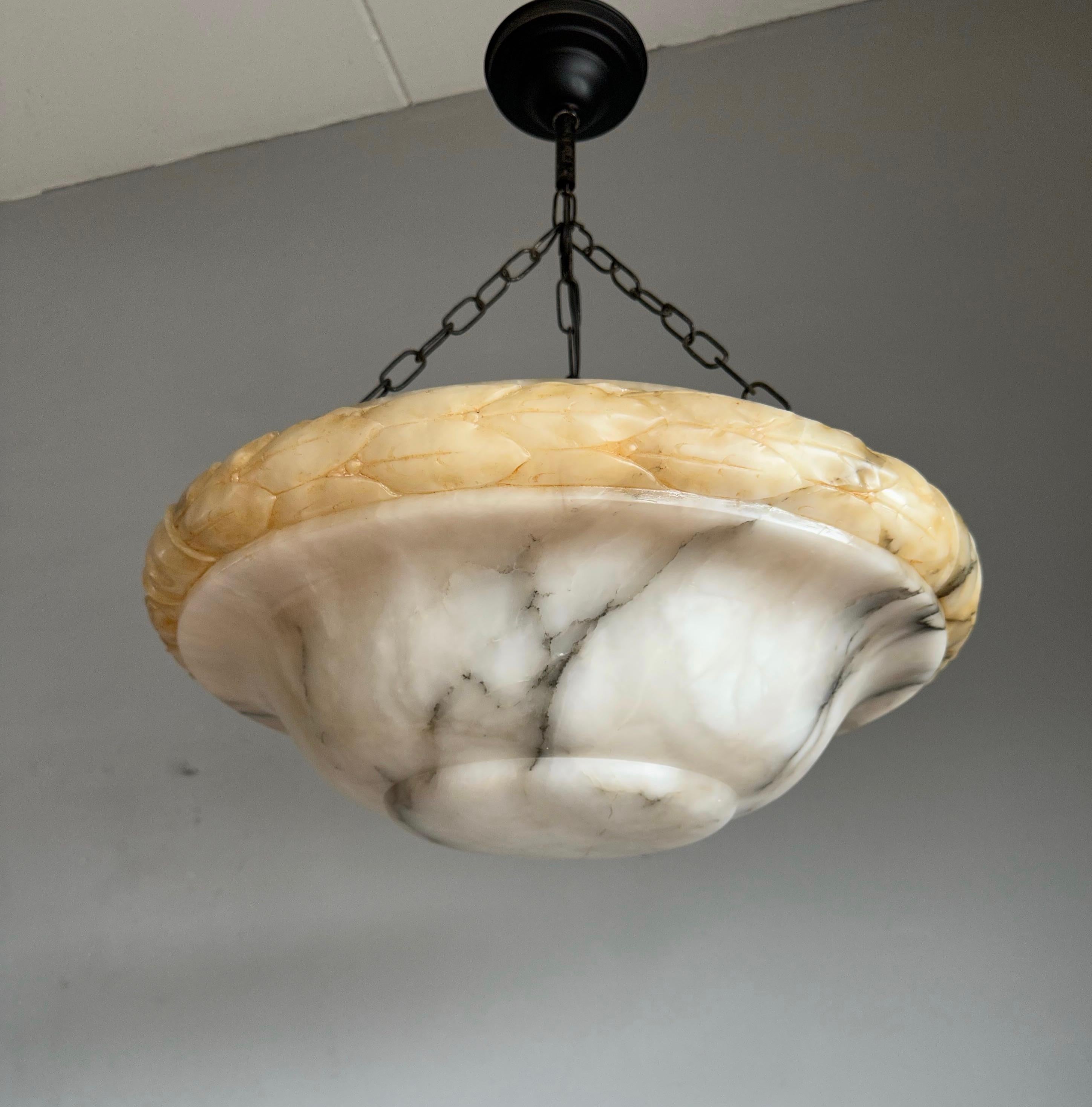 Top class Art Deco pendant with a hand carved alabaster dish shade with stunning black thunder stroke veins and leaf carvings.

Thanks to its large size and stylish design this triple light alabaster chandelier can be used and enjoyed in all kinds