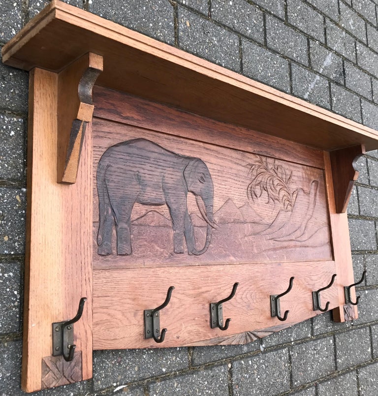 Stunning, solid oak coat rack with rare wildlife scene.

In the beginning of the 20th century only very few people would have ever seen an elephant in real life. Since artists such as painters, carvers, sculptors and all other kinds of crafstman