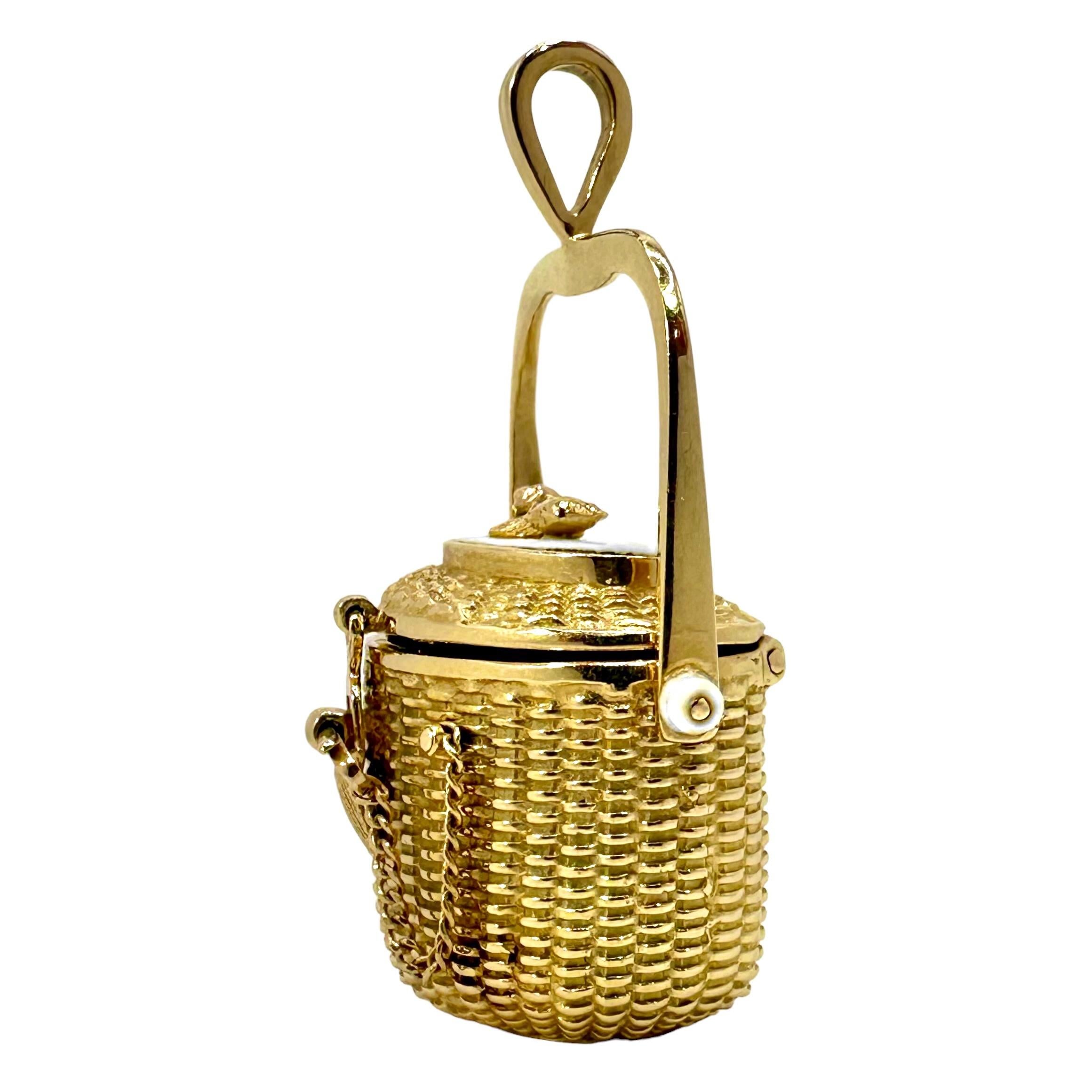 A fun Nantucket basket, in a unique kidney shape that is crafted in 14K yellow gold with a true to life basket weave texture. This charming pendant features the iconic heart charm inside, traditionally used by Diana Kim England in all her baskets.