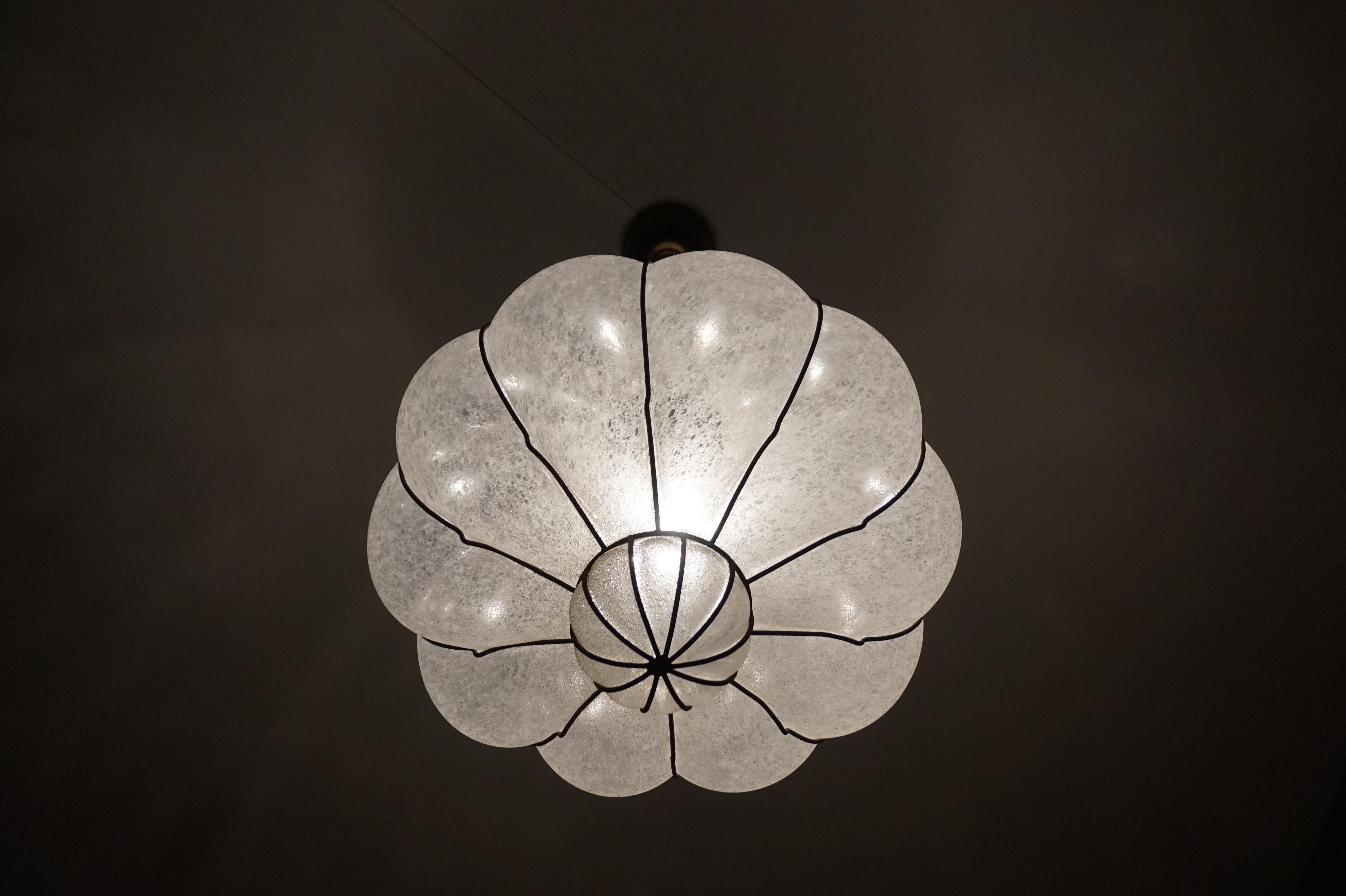 Stunning midcentury made Italian light fixture.

To give you a better idea of the unique size of this striking, frosted glass Murano pendant we have added image 7 where it is placed on a modern desk chair. In our other images this rare light is