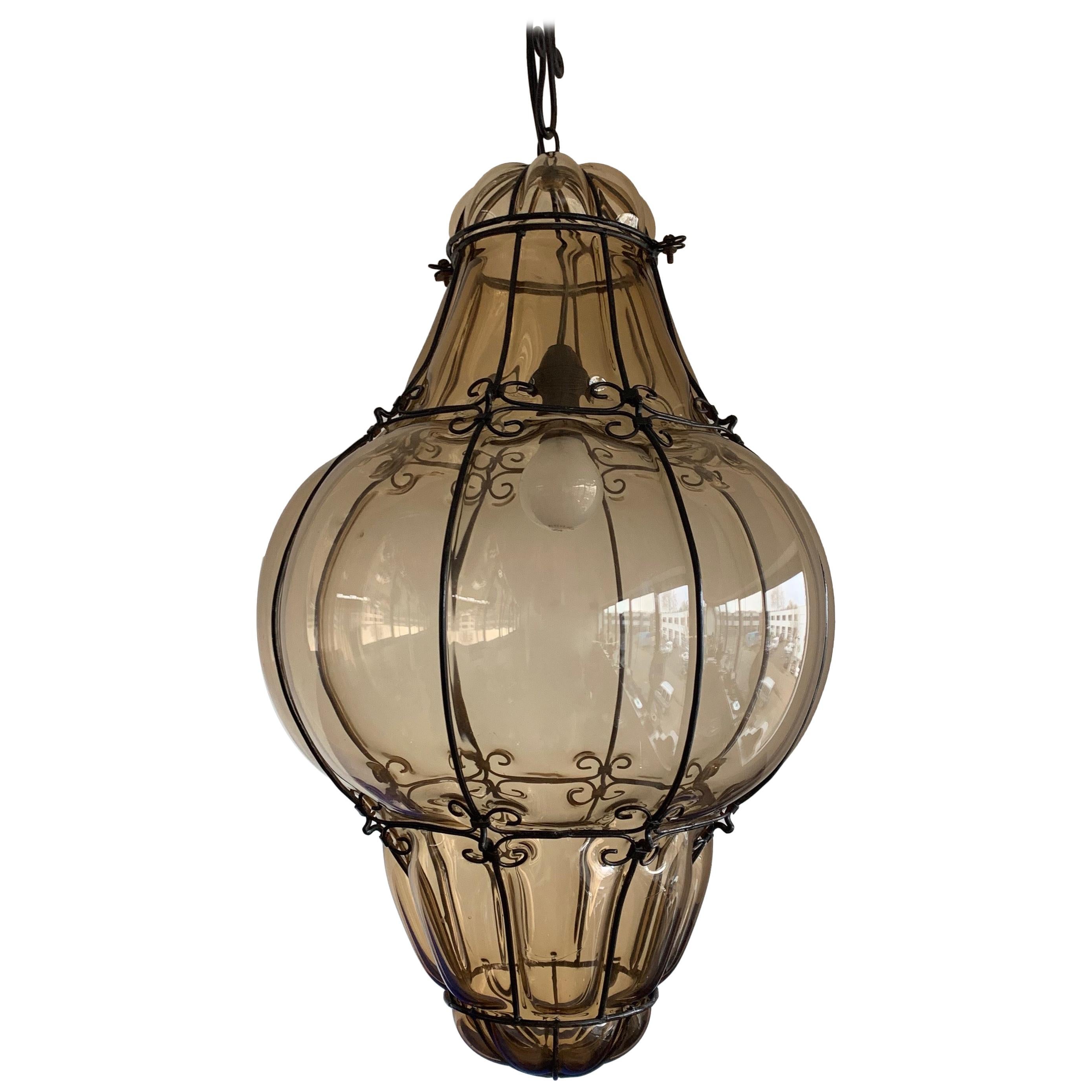 Extra large, Italian Murano mouth blown chandelier.

To give you a better idea of the extra large and wonderful size of this striking, smoked glass fixture we have added image 7 and 8 where it is put on a serving table and placed in a large lounge