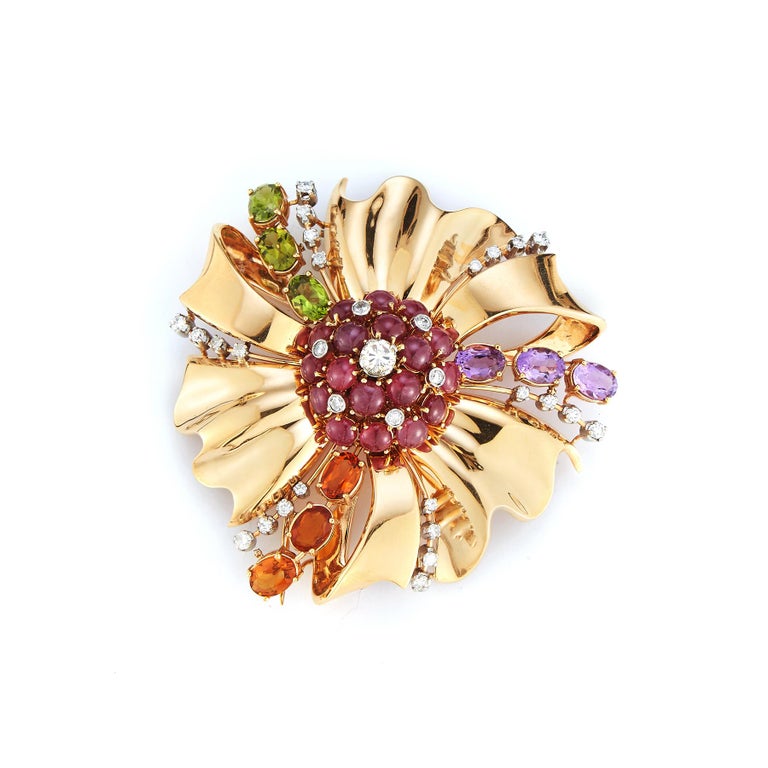 Mutli Gem and Diamond Flower Brooch:
Set with: Ruby Citrine peridot Amethyst and Diamond
Measurements: 2 inches long,  2.25 inches wide
Made Circa 1940
