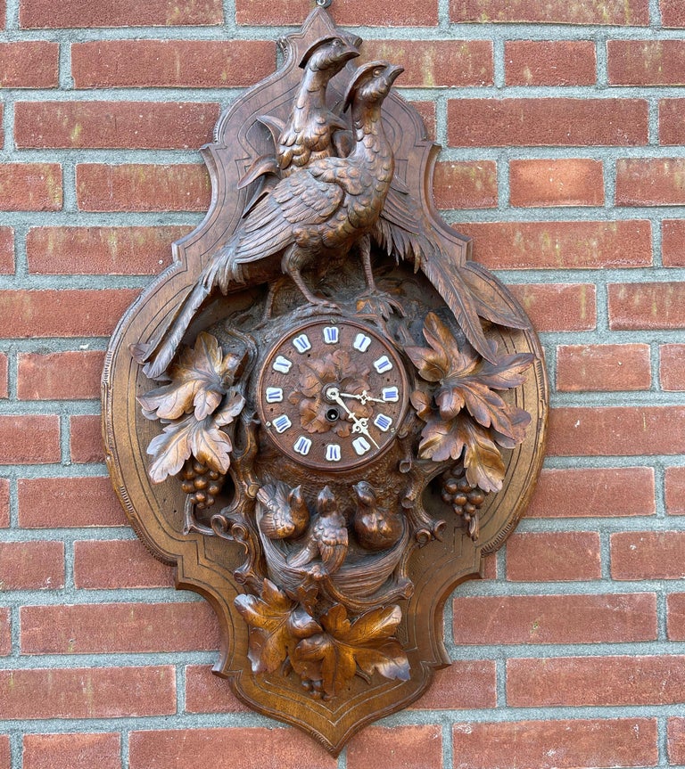 This large Swiss masterpiece wall plaque with clock is in perfect condition.

The realistic and detailed carving consists of a pair of pheasant, a bird's nest, fine leafs and branches. The warm patina makes this grandeur Black Forest work of art a