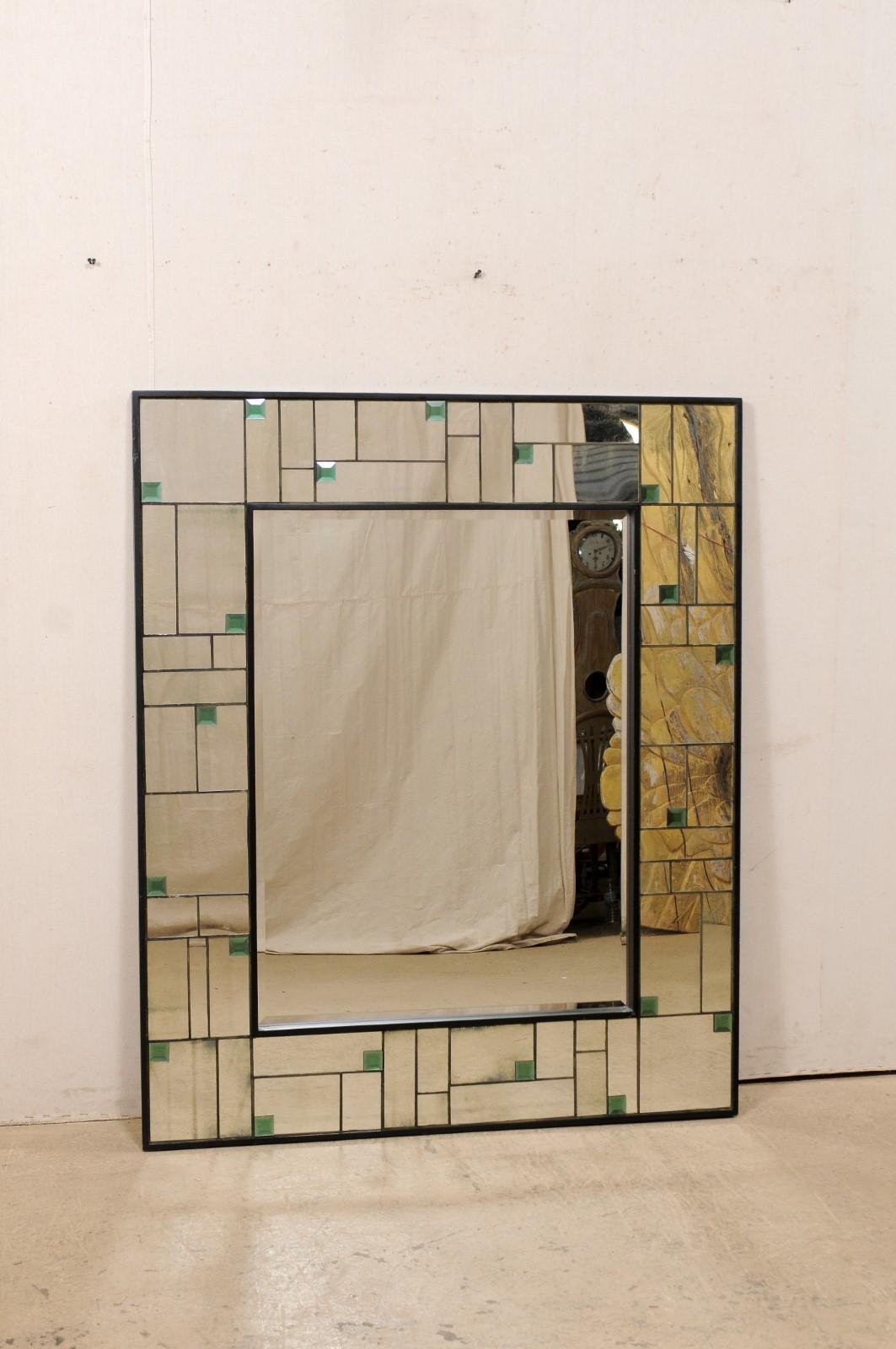 A vintage American larger-sized mirror with glass frame with green accents. This rectangular shaped mirror stands approximately 58