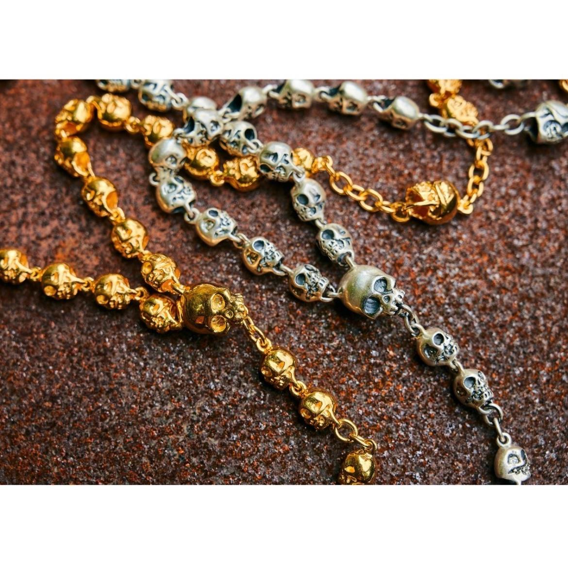 This Large Skull Rosary by Jade Jagger is crafted in gold-plated sterling silver, featuring prominent, sculpted skull beads arranged along a generously proportioned chain. Each skull is intricately detailed, lending depth and texture to the design.