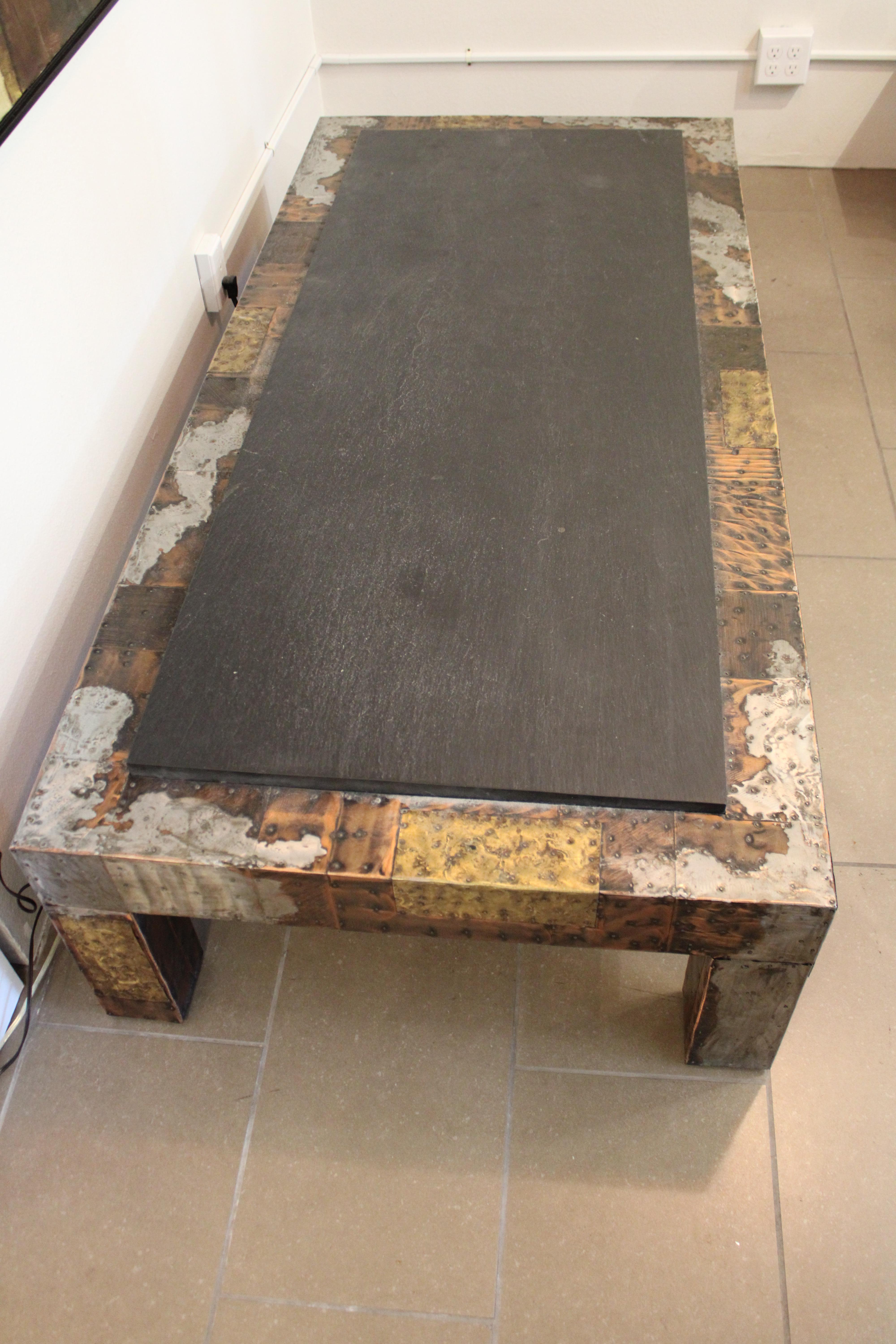 Brutalist patchwork coffee table with slate top by Paul Evans. The base is a variety of metals patchworked together to create an amazing mosaic of color and texture.  Table measures 32