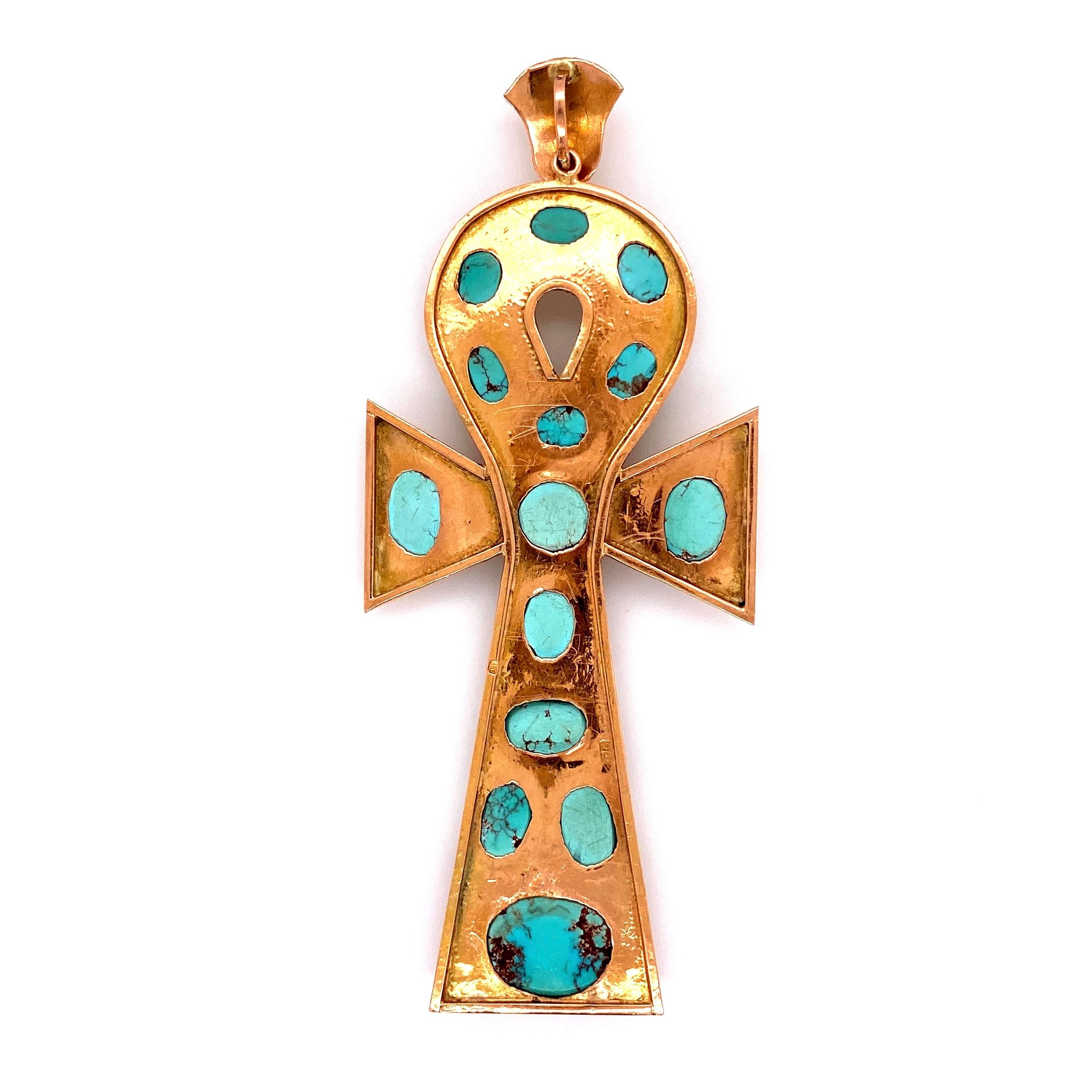 Beautiful 12 Karat Gold Ankh used in Ancient Egypt as a symbol of life. The Ankh is hand set with 14 Sleeping Beauty cabochon Turquoise. Approx. size: 3.8