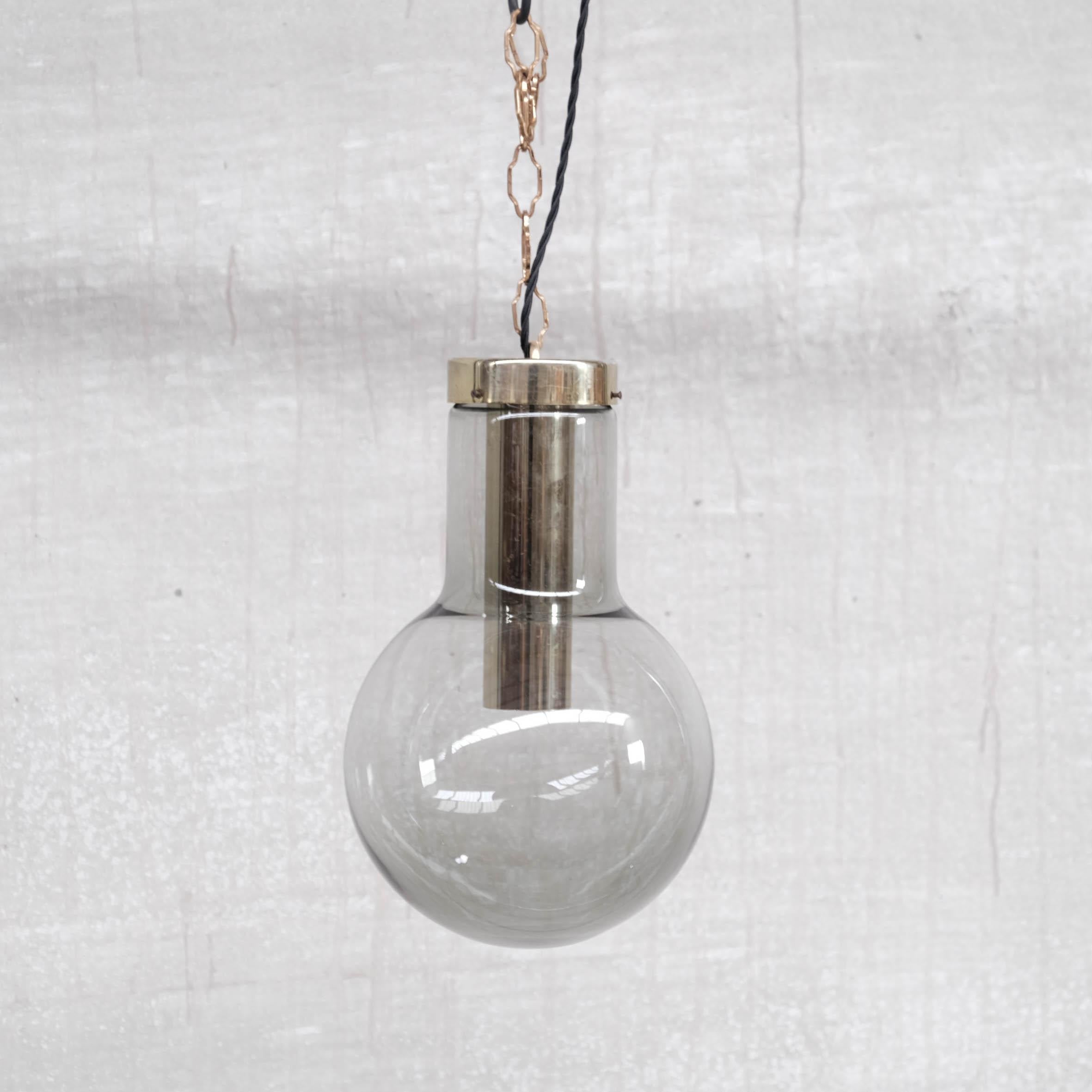 Una lampada a sospensione in vetro fumé con gallerie in ottone.

Olanda, circa anni '1980.

Buone condizioni vintage, alcuni graffi e patina commisurati all'età.

Due disponibili al momento dell'annuncio. Sei modelli leggermente più piccoli