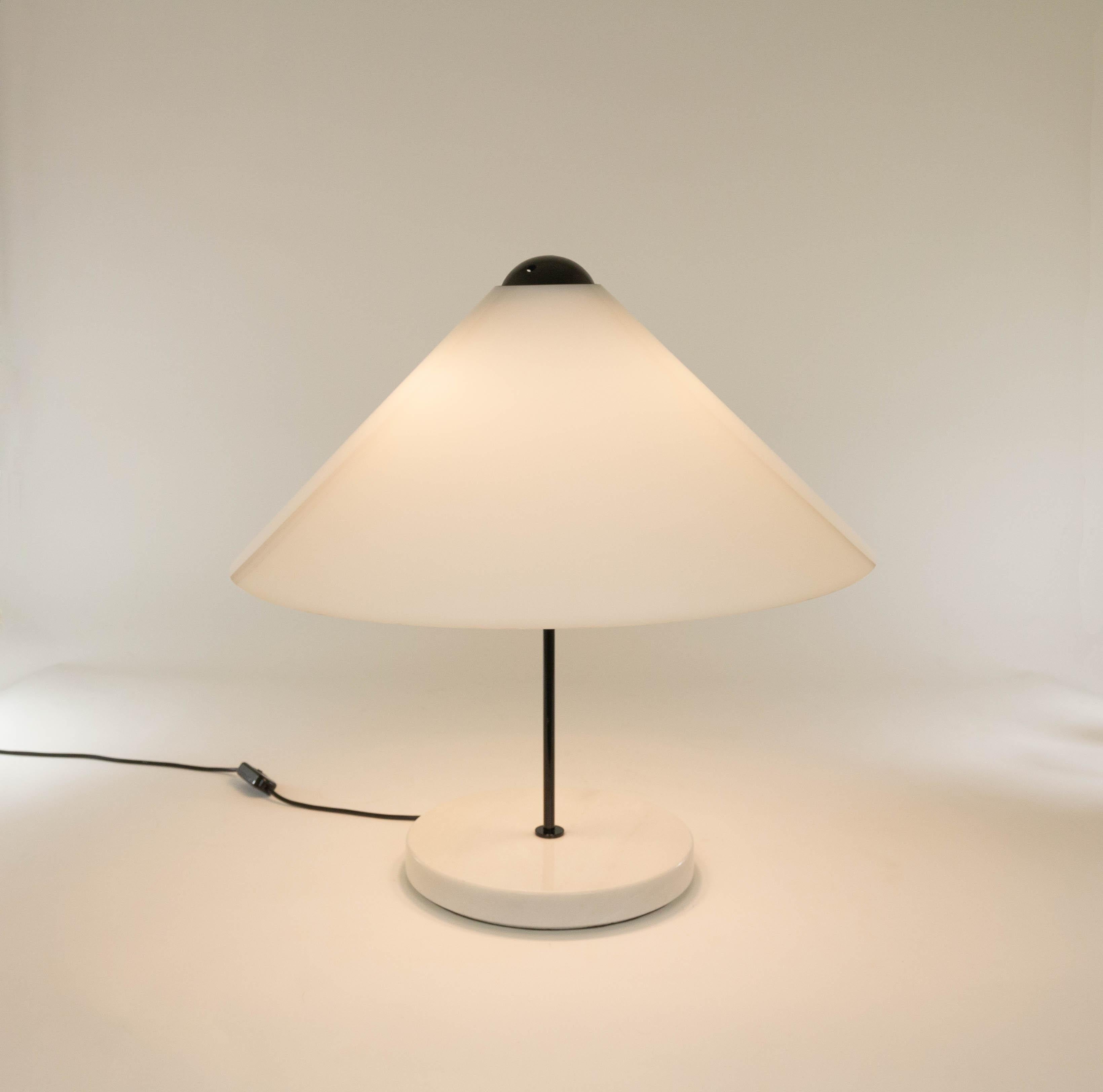 Large Snow 201 table lamp designed by Vico Magistretti (in 1973) and manufactured by O-luce as from 1974.

The table lamp features a white marble cylindrical base, black lacquered stem and an opal methacrylate cone shaped shade. The end of the