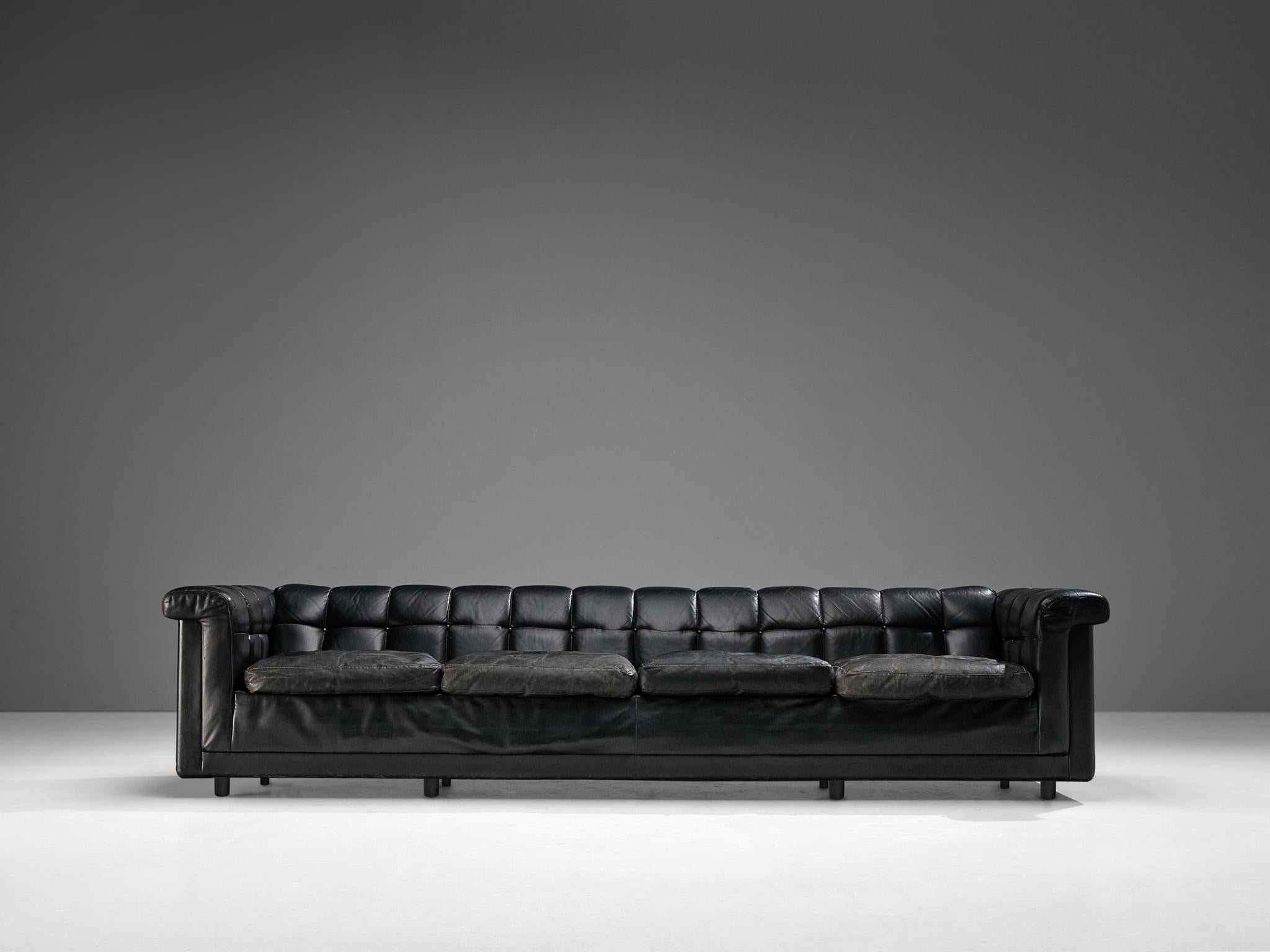 Sofa, leather, wood, Nothern Europe, 1980s

This sofa has an interesting appearance of a classic chesterfield chair with a modern aesthetic. The outside is tight and sleek. The patinated black leather upholstery emphasizes the modern look of the