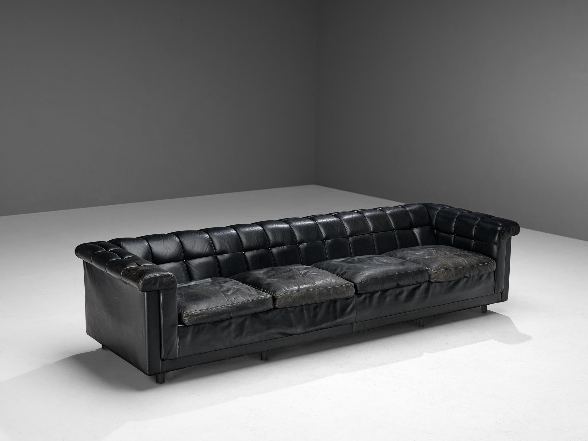 Sofa, leather, wood, Nothern Europe, 1980s

This sofa has an interesting appearance of a classic chesterfield chair with a modern aesthetic. The outside is tight and sleek. The thick padded backrest and armrests feature a geometric surface with