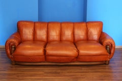 large sofa in cognac colored leather in the style of sergio rodriguez