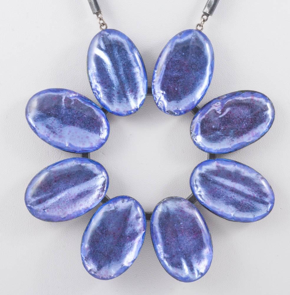 
A fabulous enamelled pendant, hand made in Paris by Jacques Gautier, in a most striking and dynamic colour. Each section of the silver plated bronze necklace is textured, and the 'flower' pendant has rich enamelled 'petals' set against the same