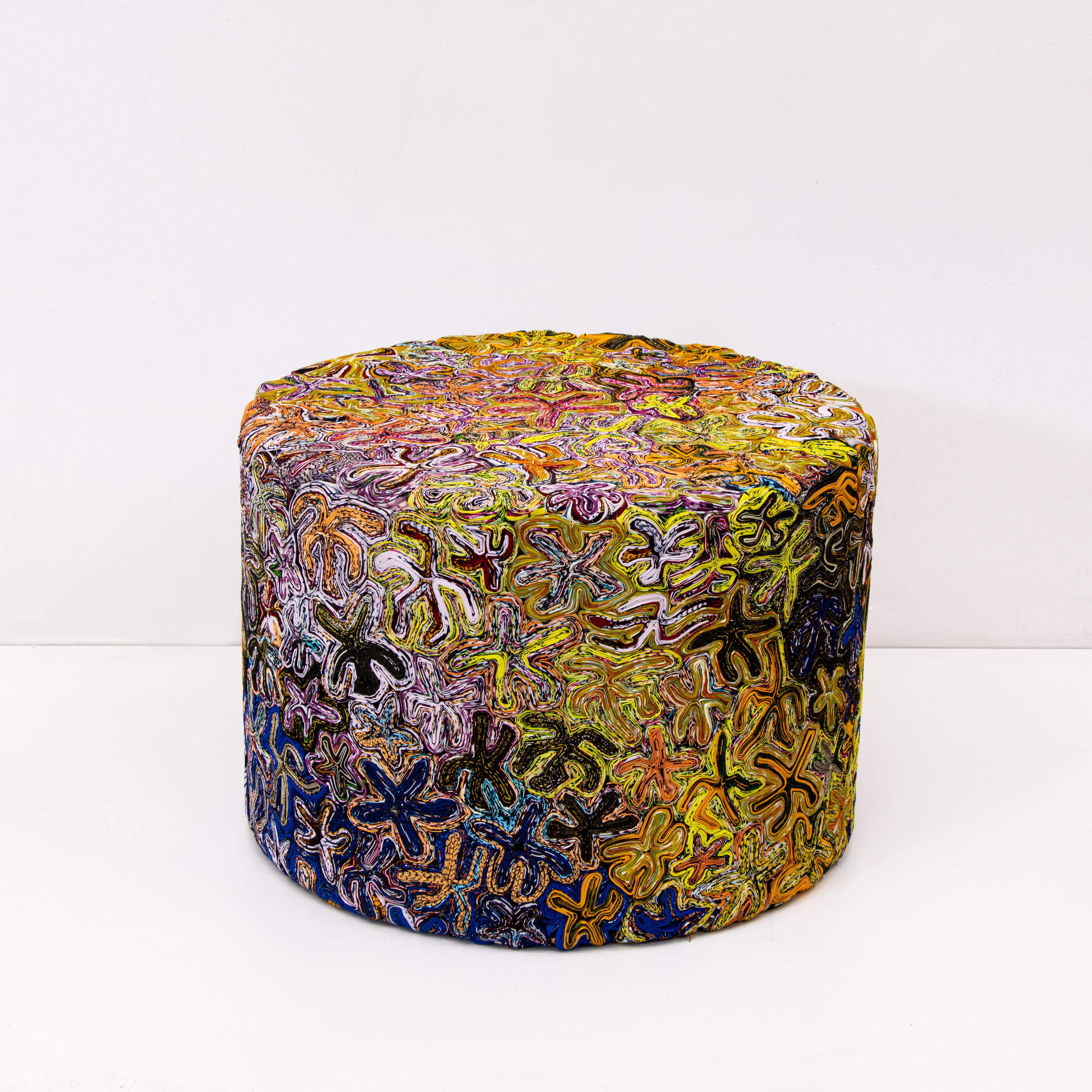 Studio Simone post - large soft stool - flower navel.

Made out of 100%cotton waxed, Vlisco textile rejects.
Simone Post took the Vlisco material one step further towards 3D objects. She covered multiple objects with Vlisco left over textiles,