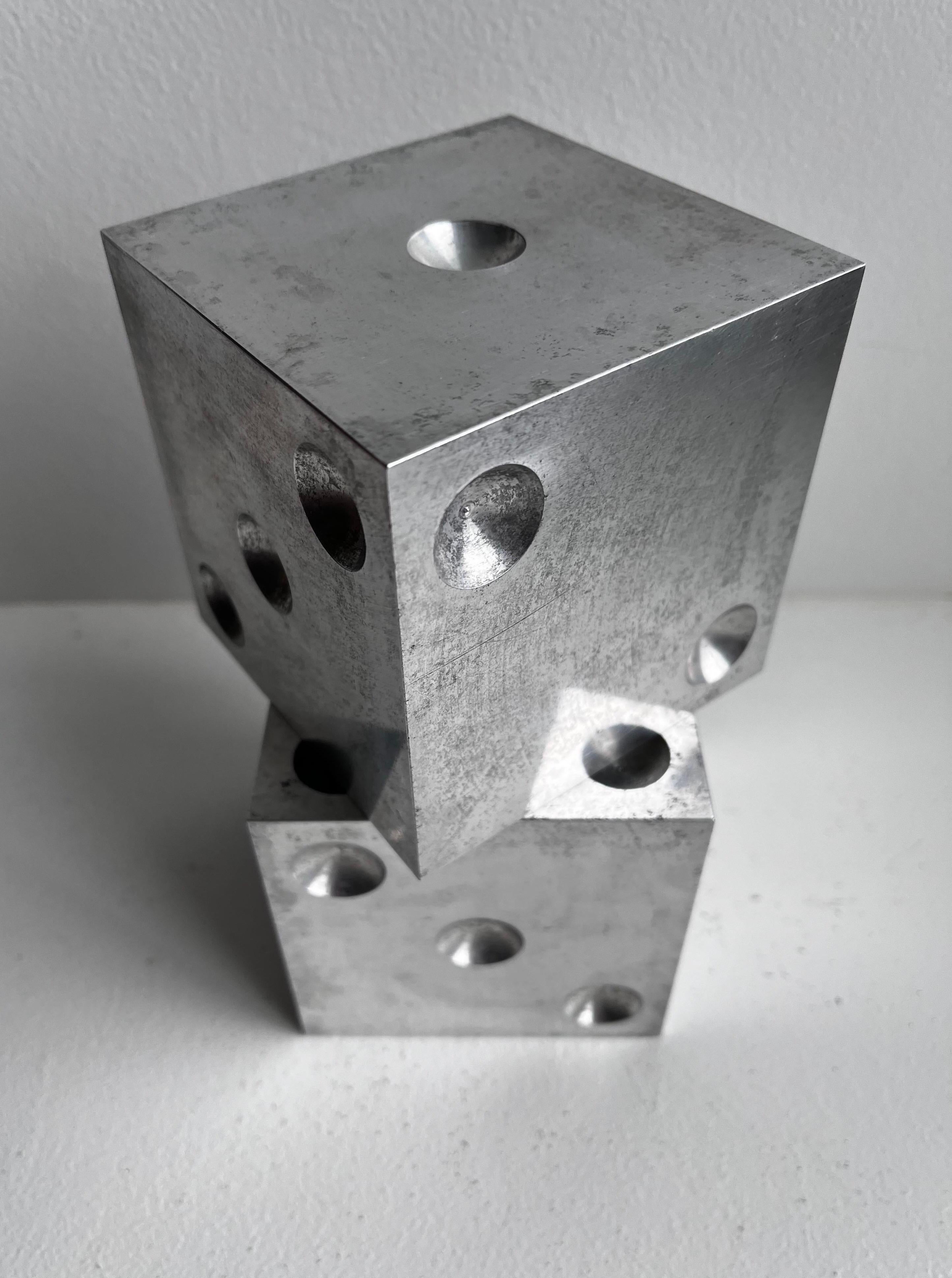 Large Dice made from solid Aluminum

Use as Sculpture.
Use as Bookends.
Use as other, you decide.

Origin, maker and year made unknown which only makes it better.
Great patina with some discoloration, edge and corners are sharp.

