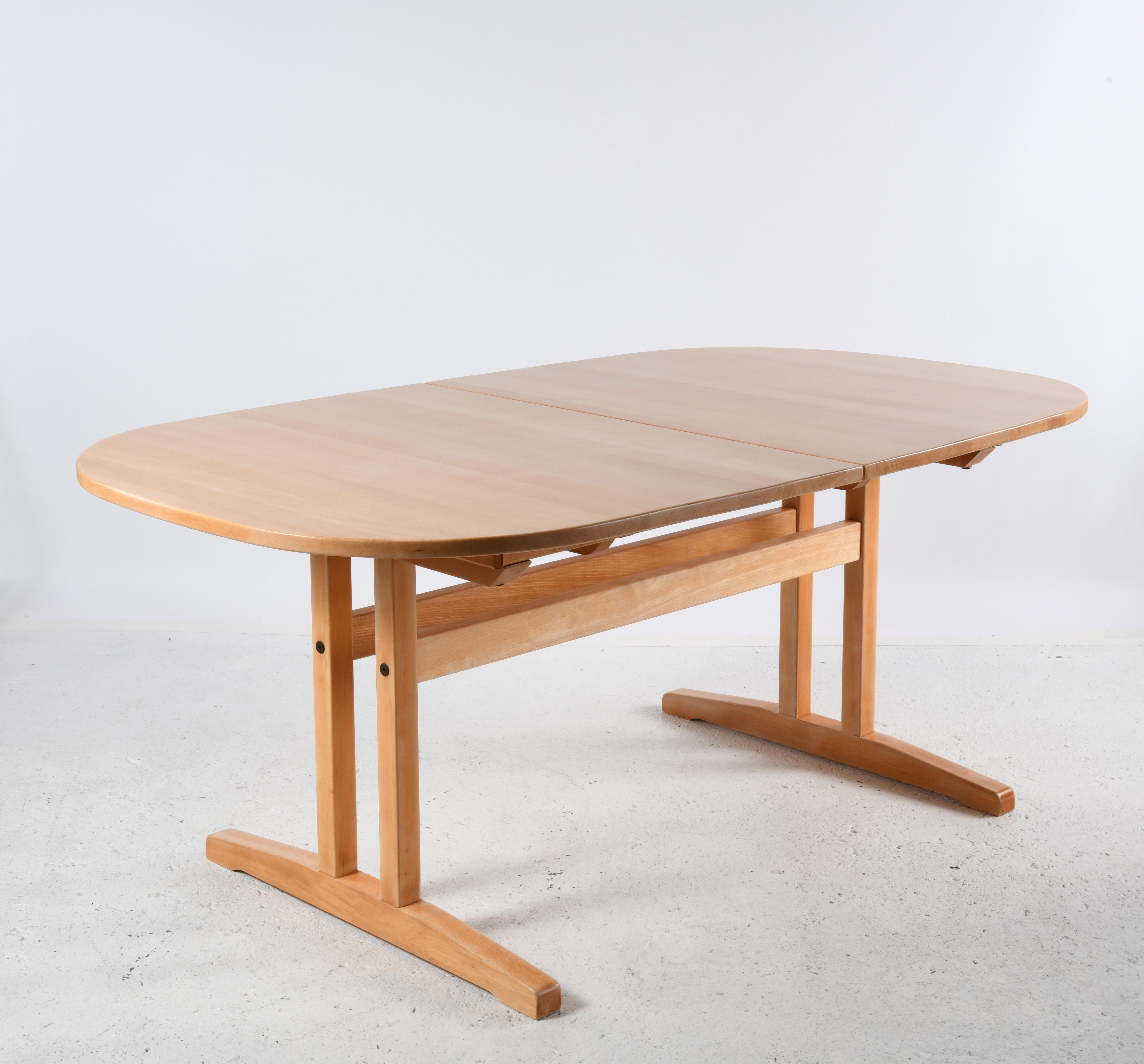 Scandinavian Modern Large solid beech oval table with sliding top and two extensions. For Sale