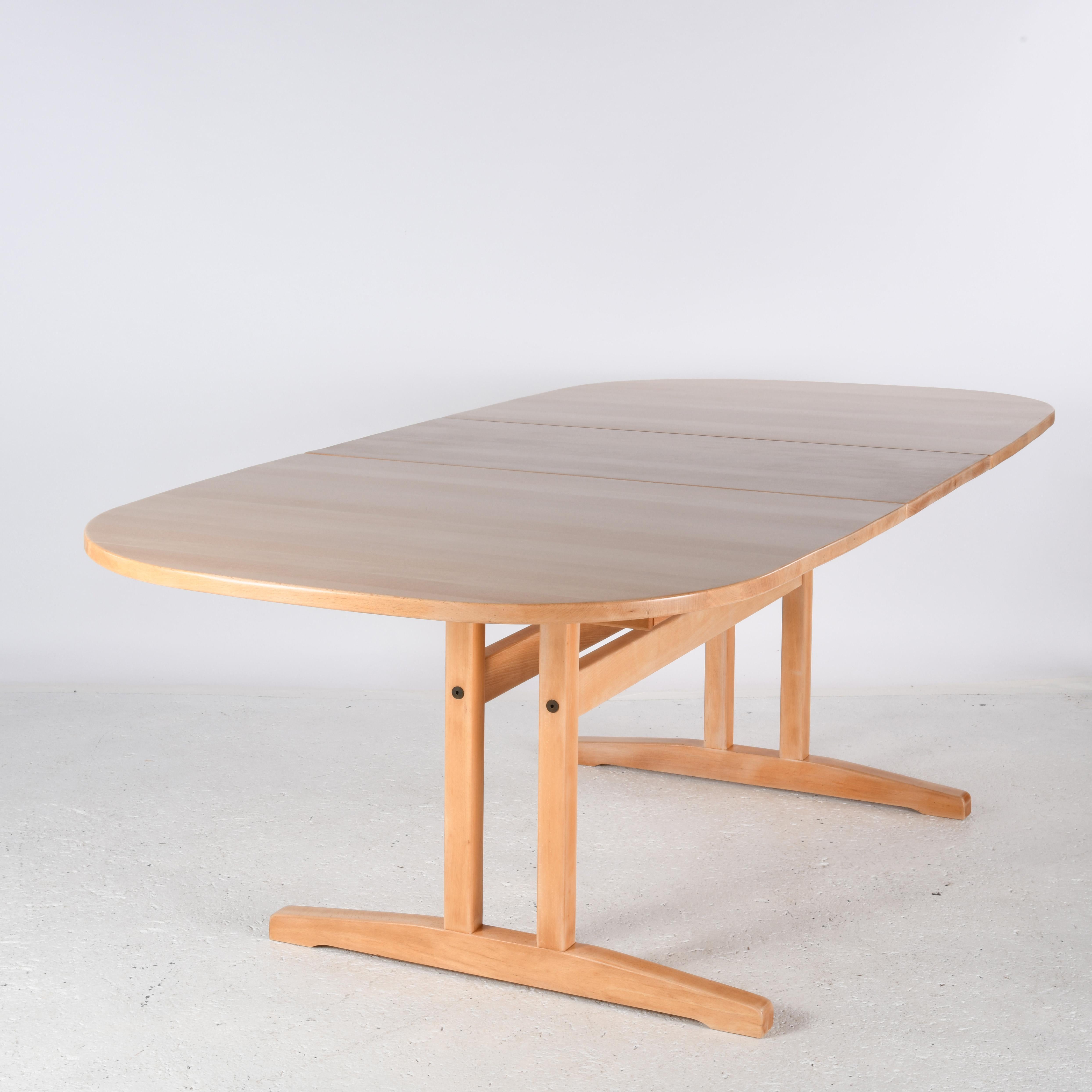 Contemporary Large solid beech oval table with sliding top and two extensions. For Sale