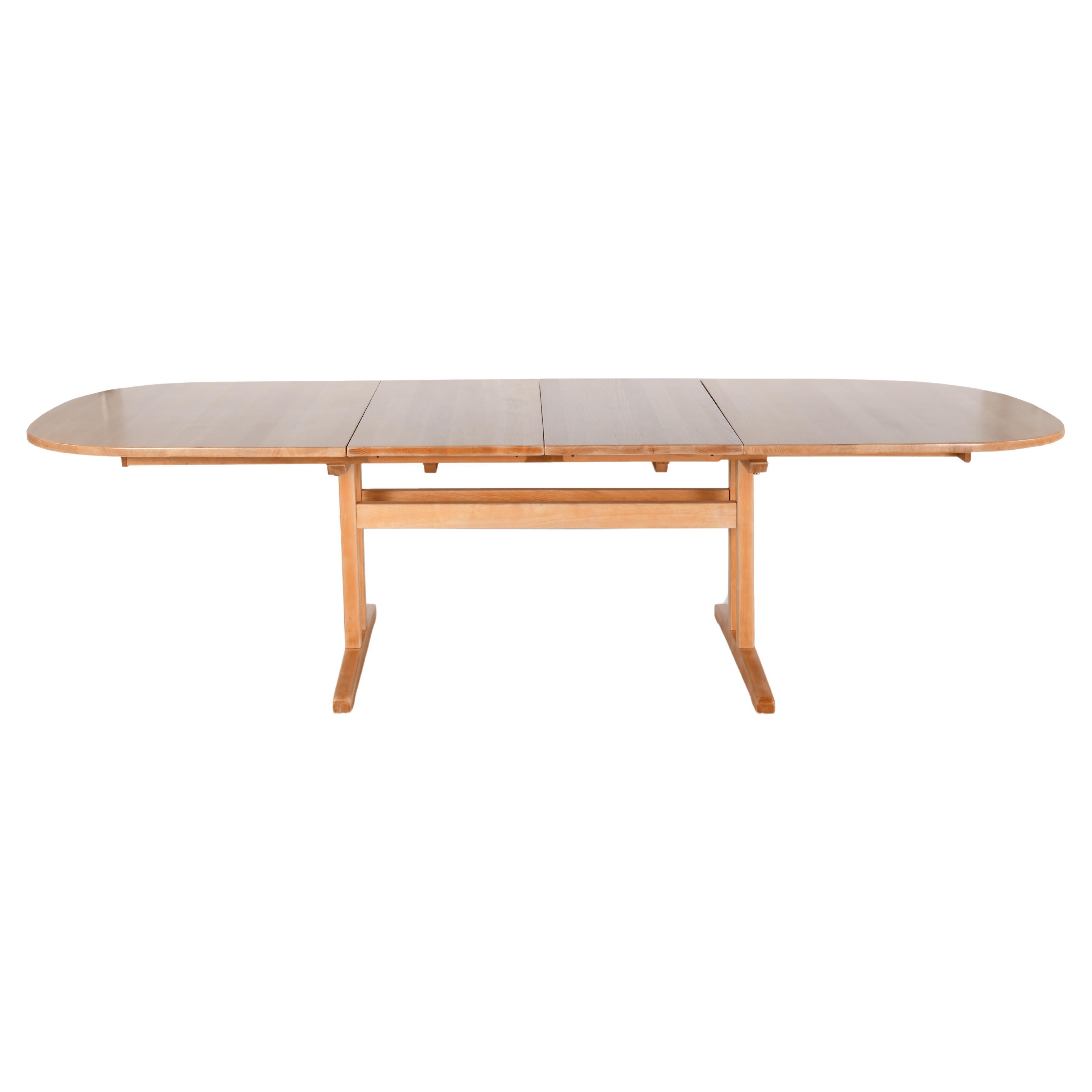 Large solid beech oval table with sliding top and two extensions.