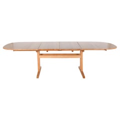 Used Large solid beech oval table with sliding top and two extensions.