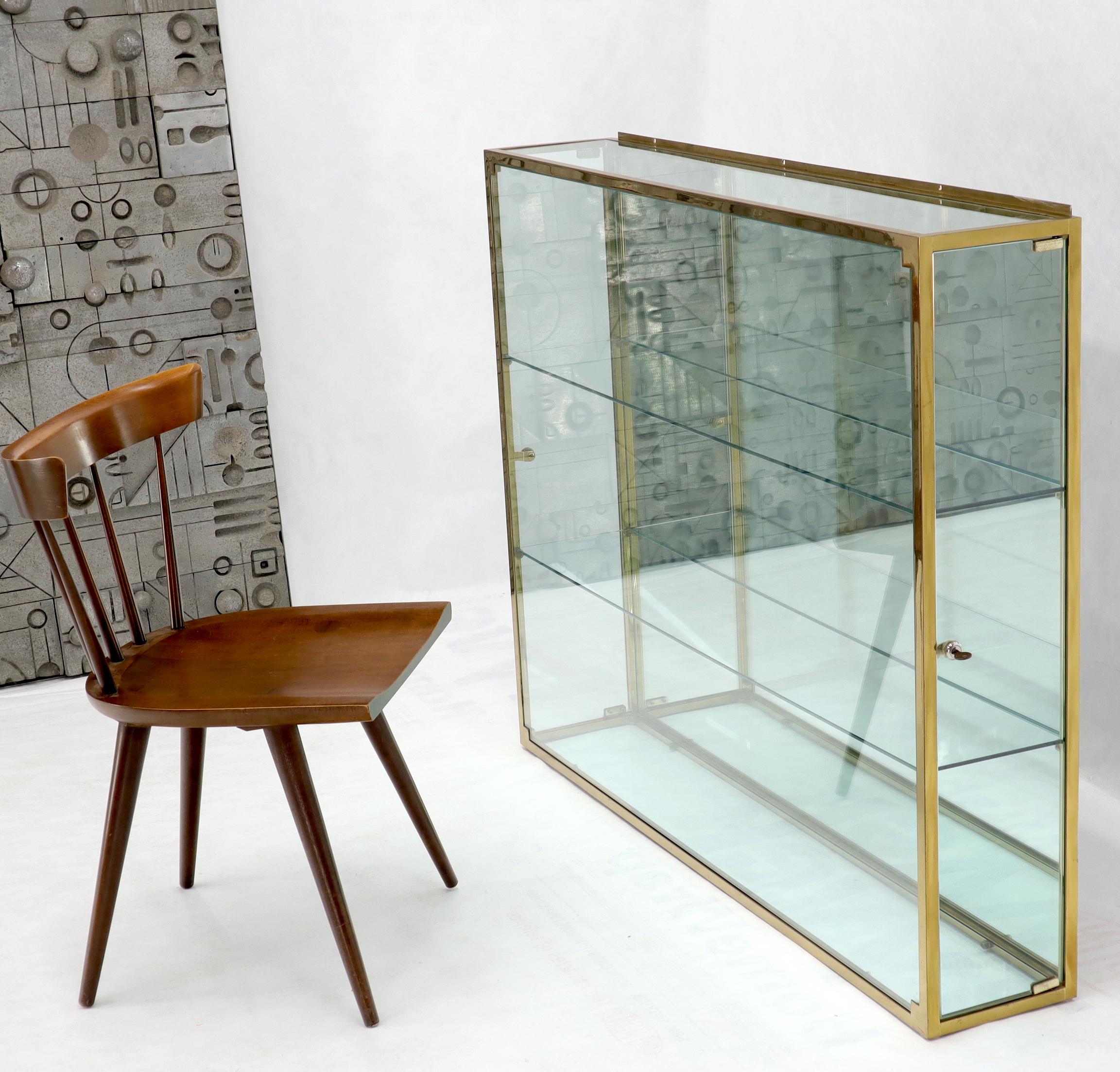 Mid-Century Modern custom polished brass frame and glass hanging curio display cabinet shelving unit. Paul McCobb, Probber era.