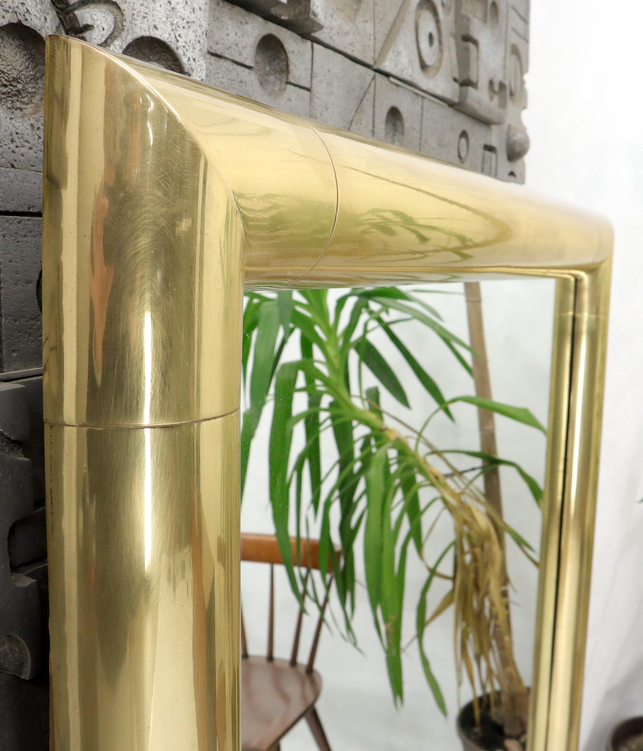 Mid-Century Modern large solid brass round profile rectangular mirror attributed to Karl Springer.