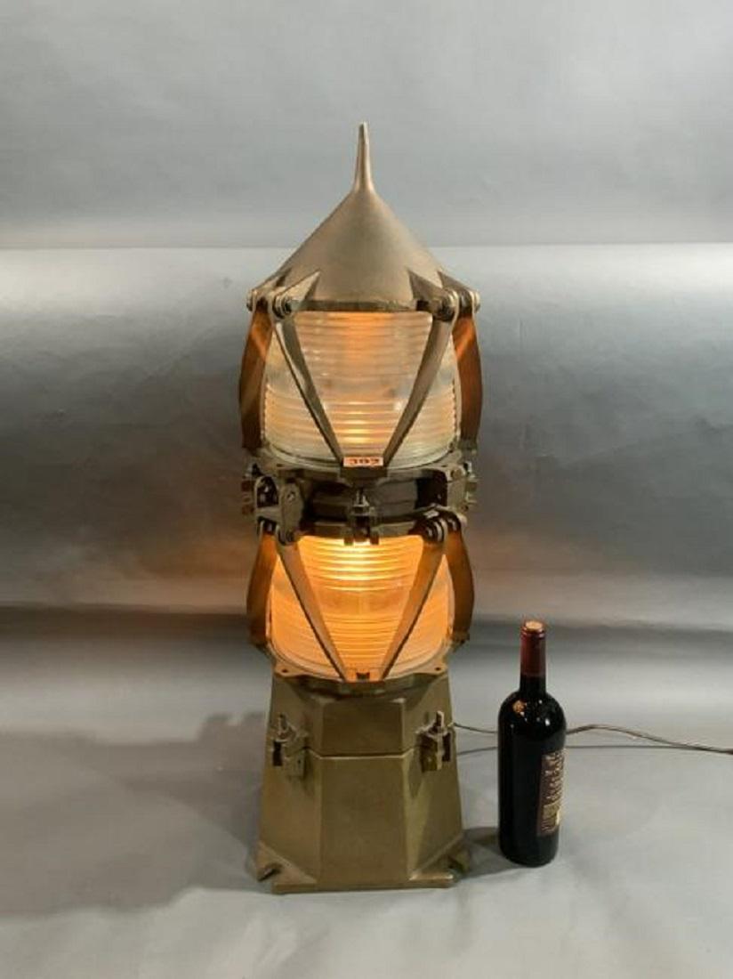 Large solid rough cast bronze marine beacon fitted with two Fresnel lenses. Unit is electrified. With protective bars.

Overall dimensions: 33