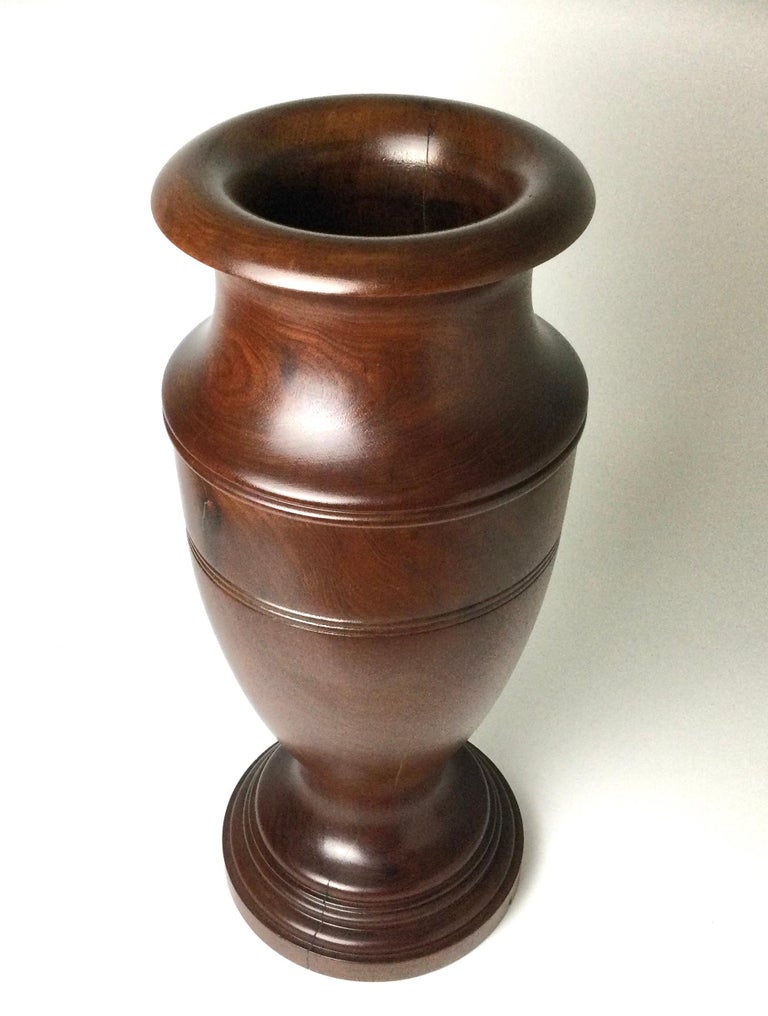This example is made from one solid piece of mahogany. Hand turned. It has been re-finished and has some natural checking of the wood. Stands 23 1/4