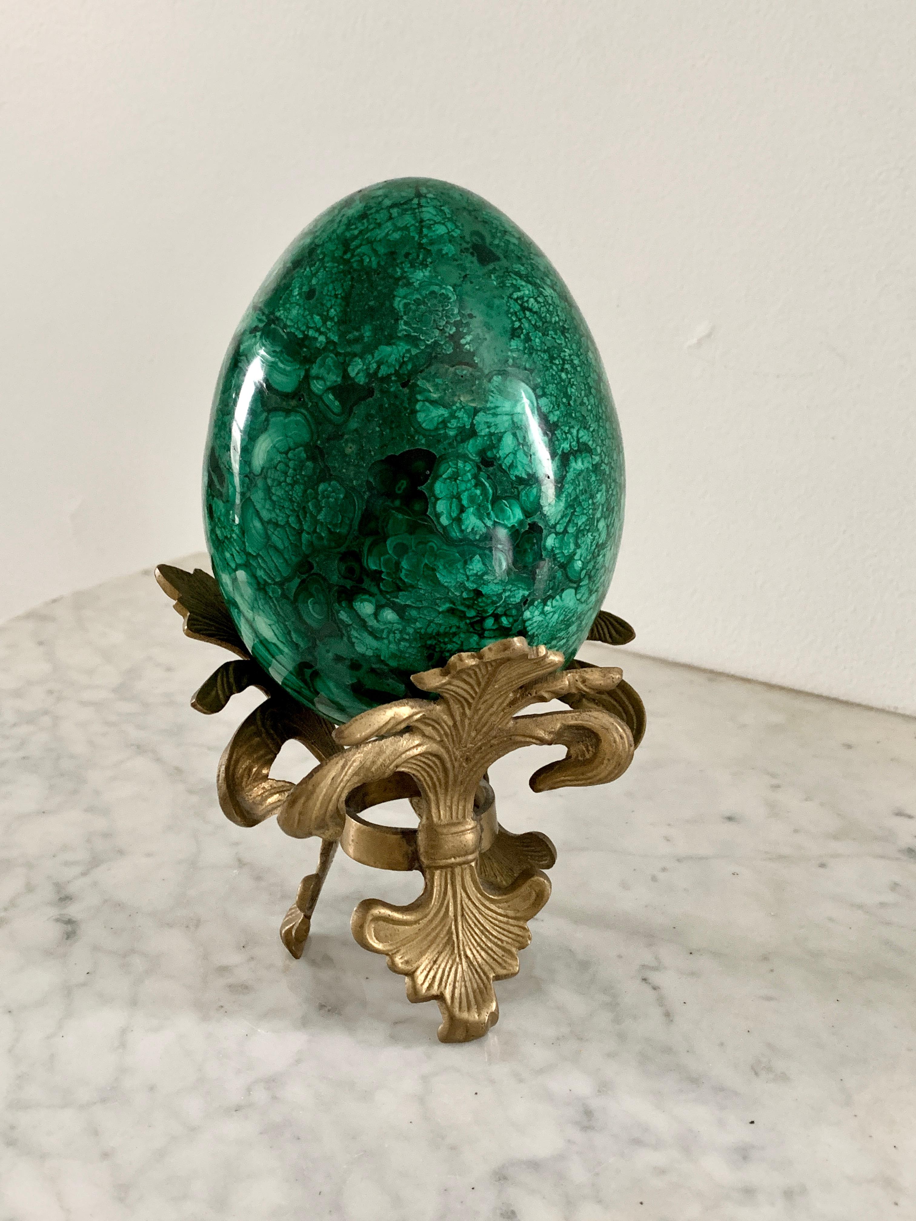 A stunning Russian style large malachite egg on Neoclassical style stand

Late 20th century

Solid malachite egg, with cast brass stand

Measures: 5
