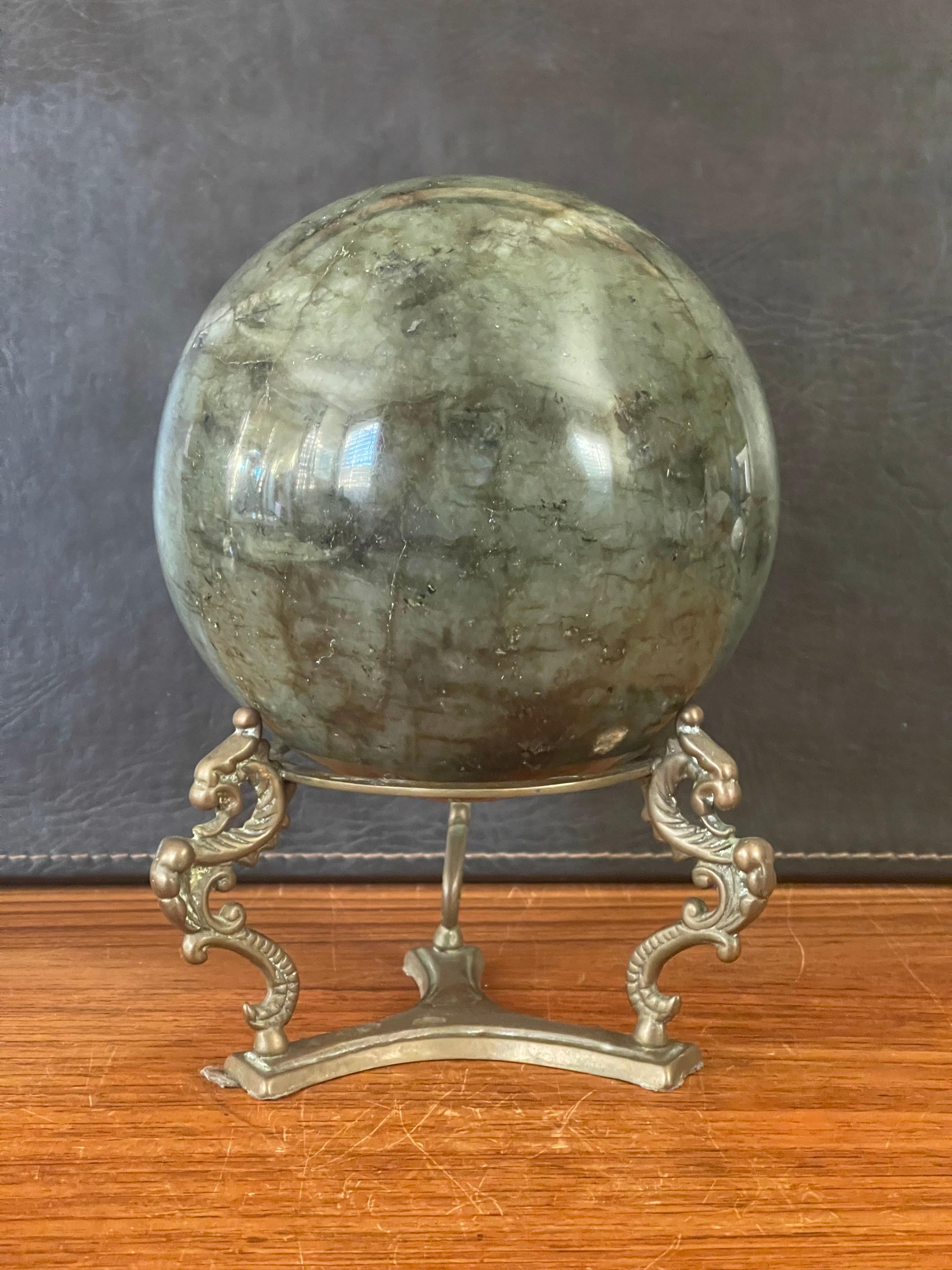 Beautiful large solid green marble decorative sphere on bronze base with three griffins, circa 1970s. The piece is in very good condition with no chips or cracks; it has a nice polished finish with with white and grey veining and speckles. The