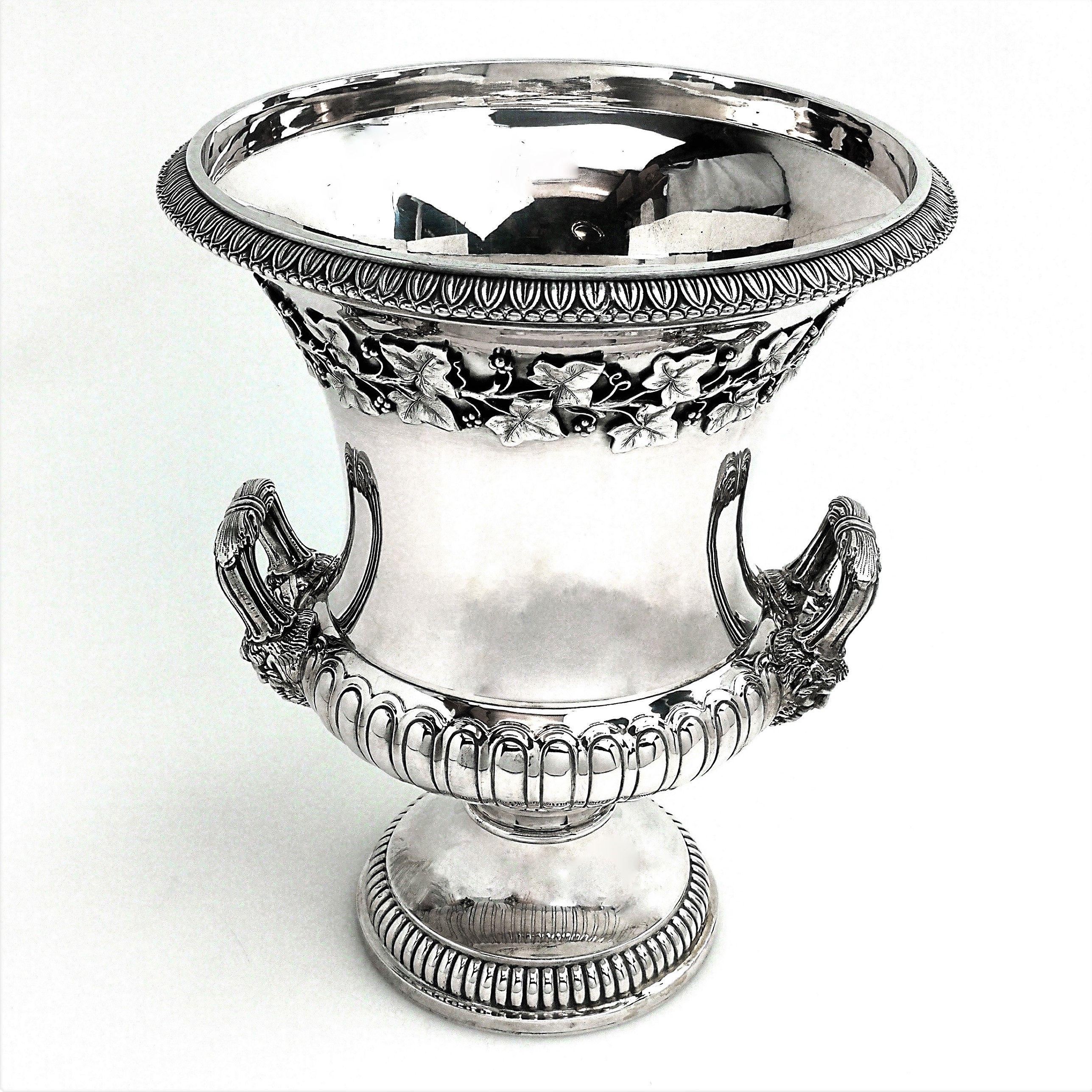 An impressive vintage Italian solid silver champagne cooler or wine ice bucket. This cooler has an elegant fluted shape withe a wide everted rim. The cooler stands on a pedestal foot and has two handles. This wine cooler is decorated with an applied