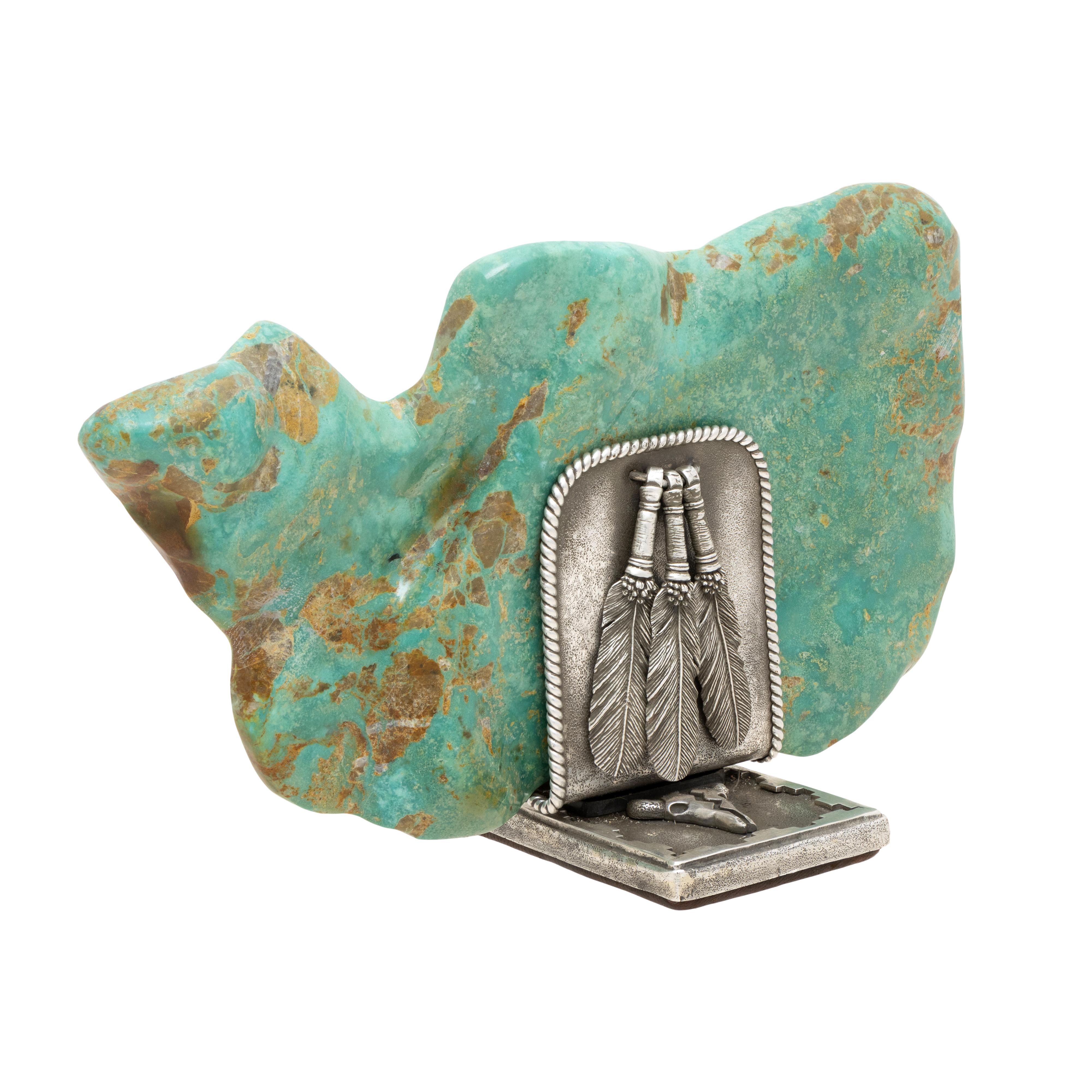 Magnificent turquoise nugget from the Hachita Mine in New Mexico. Nugget weight 5,575 cts. Mounted on custom .925 sterling silver base having silver feathers and buffalo skulls. Base custom made by artisan Jami Hansen. Exceptional and one of a